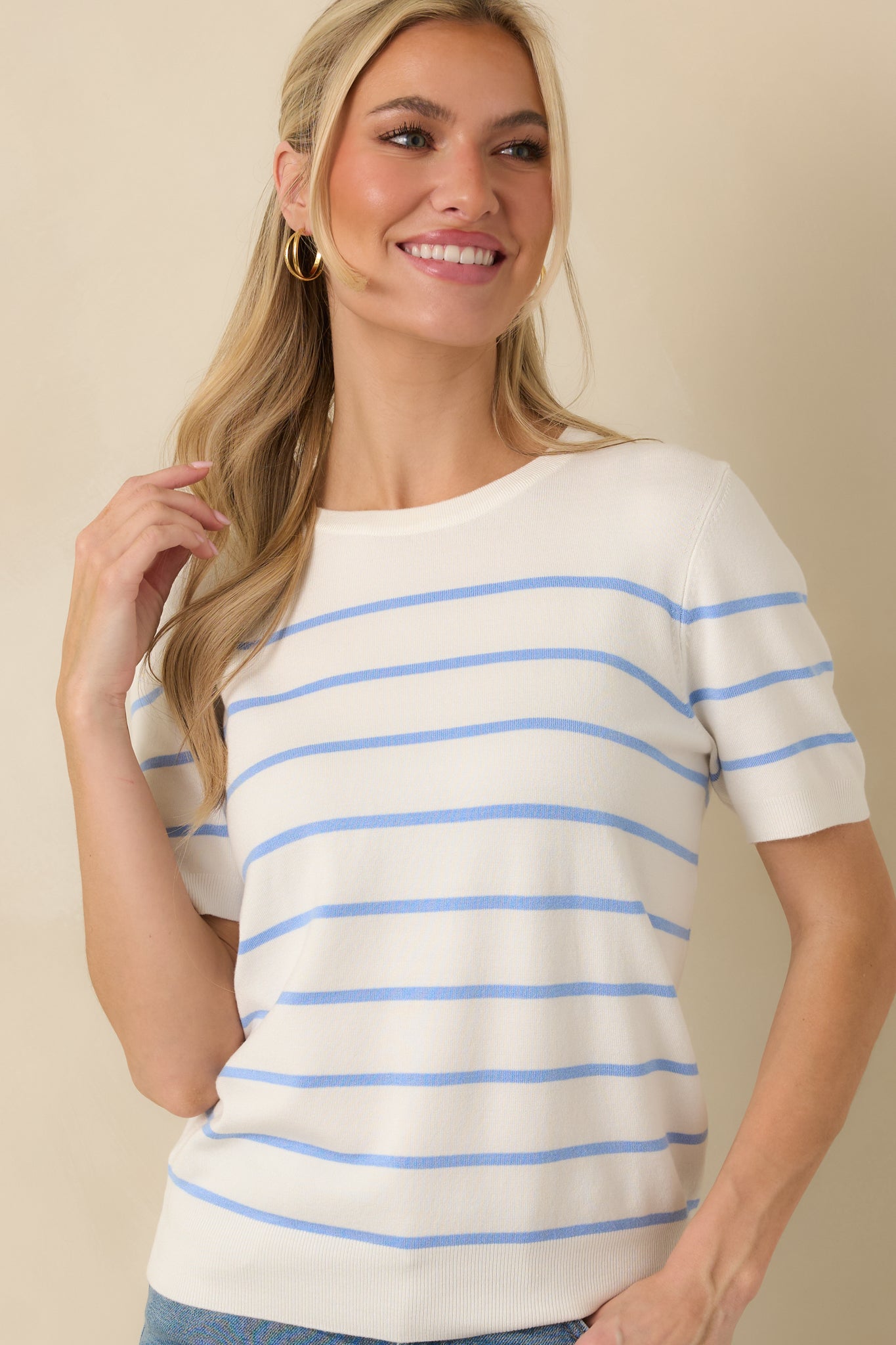 Front crop showing the lightweight fine-gauge knit texture and structured silhouette of the blue striped top.