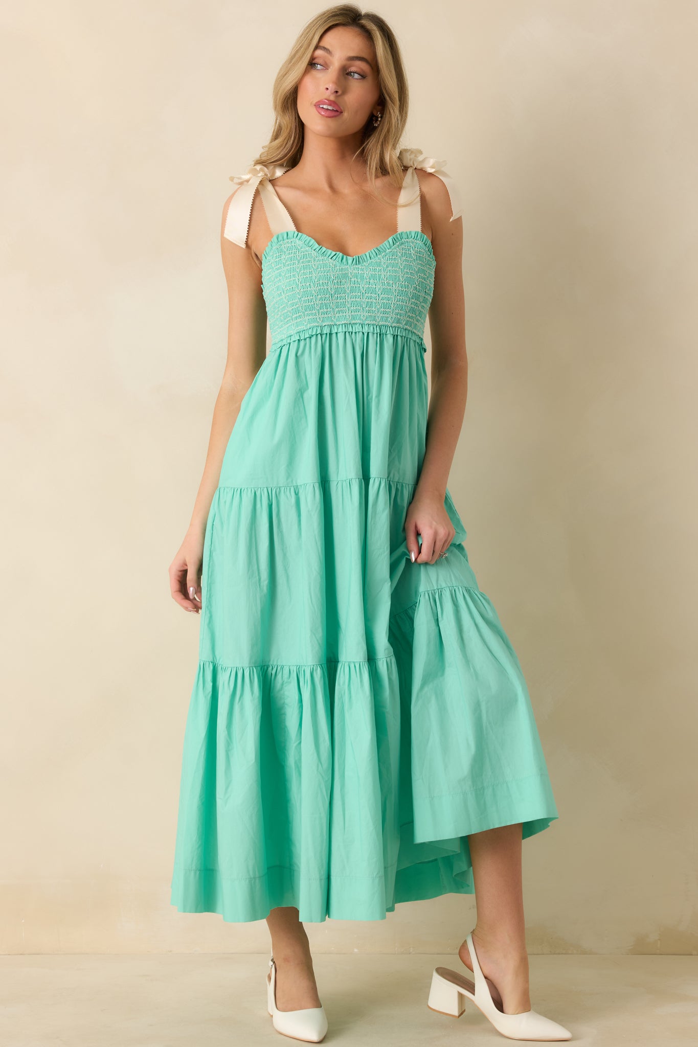 Front-facing mint green midi dress highlighting the fully smocked embroidered bodice and soft flowing hem.