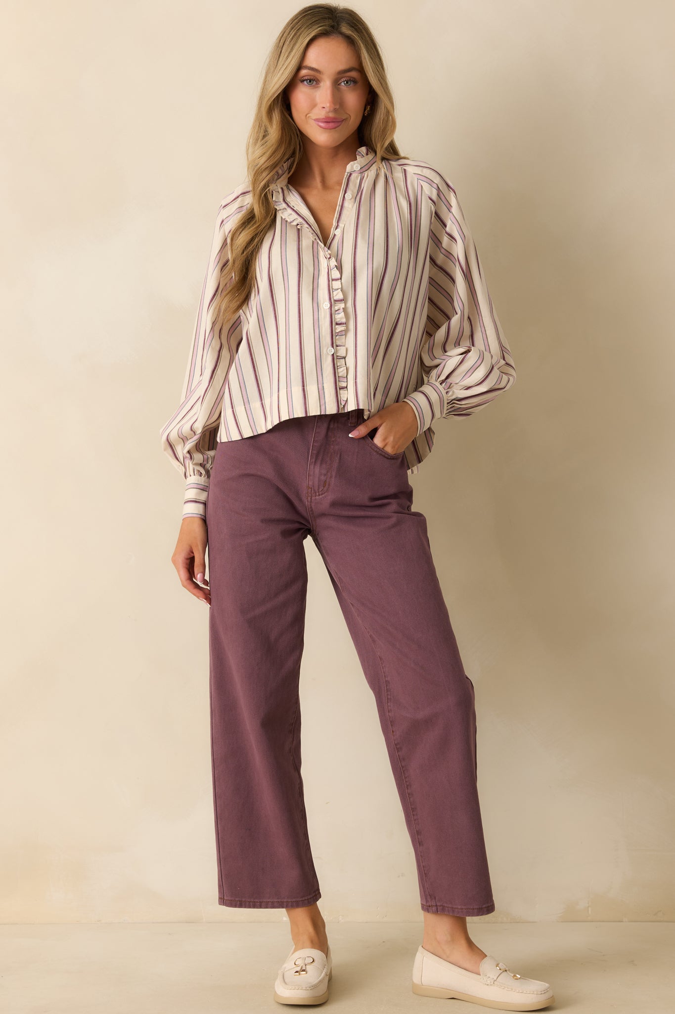 Front-facing striped shirt highlighting the ruffled placket and lightweight woven fabric in soft ivory and lilac tones.