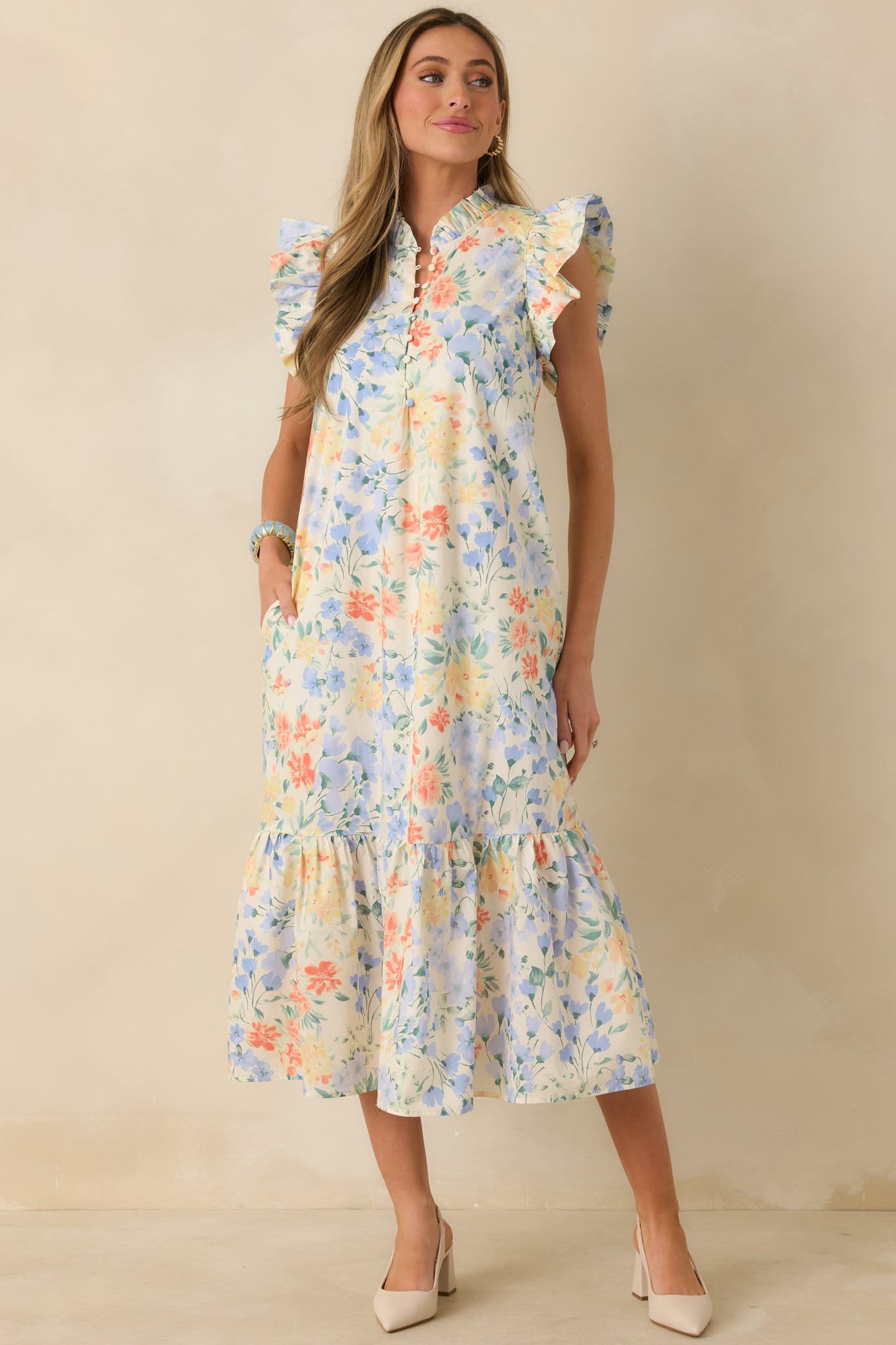 Front-facing view emphasizing the midi-length hem, tiered skirt, and allover pastel floral pattern.