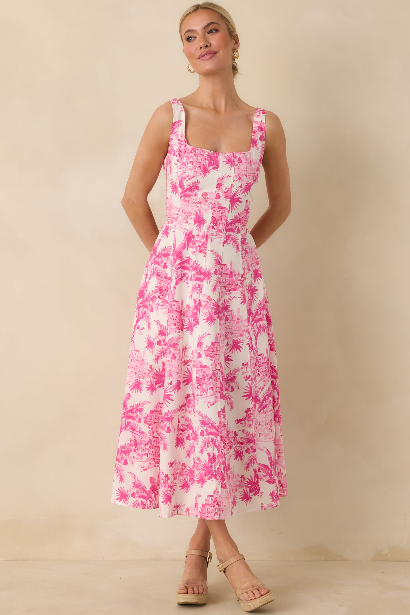 Front-facing view emphasizing the wide straps, square neckline, and relaxed fit through the skirt.