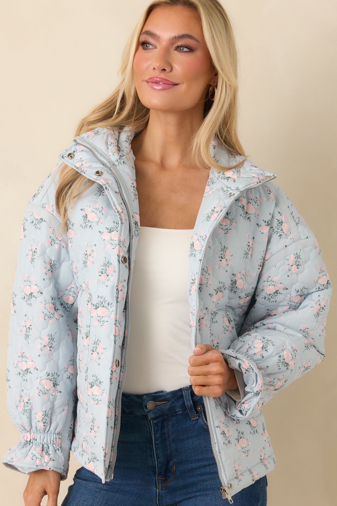 Front-focused crop emphasizing the functional pockets, soft floral quilting, and smooth fabric surface.