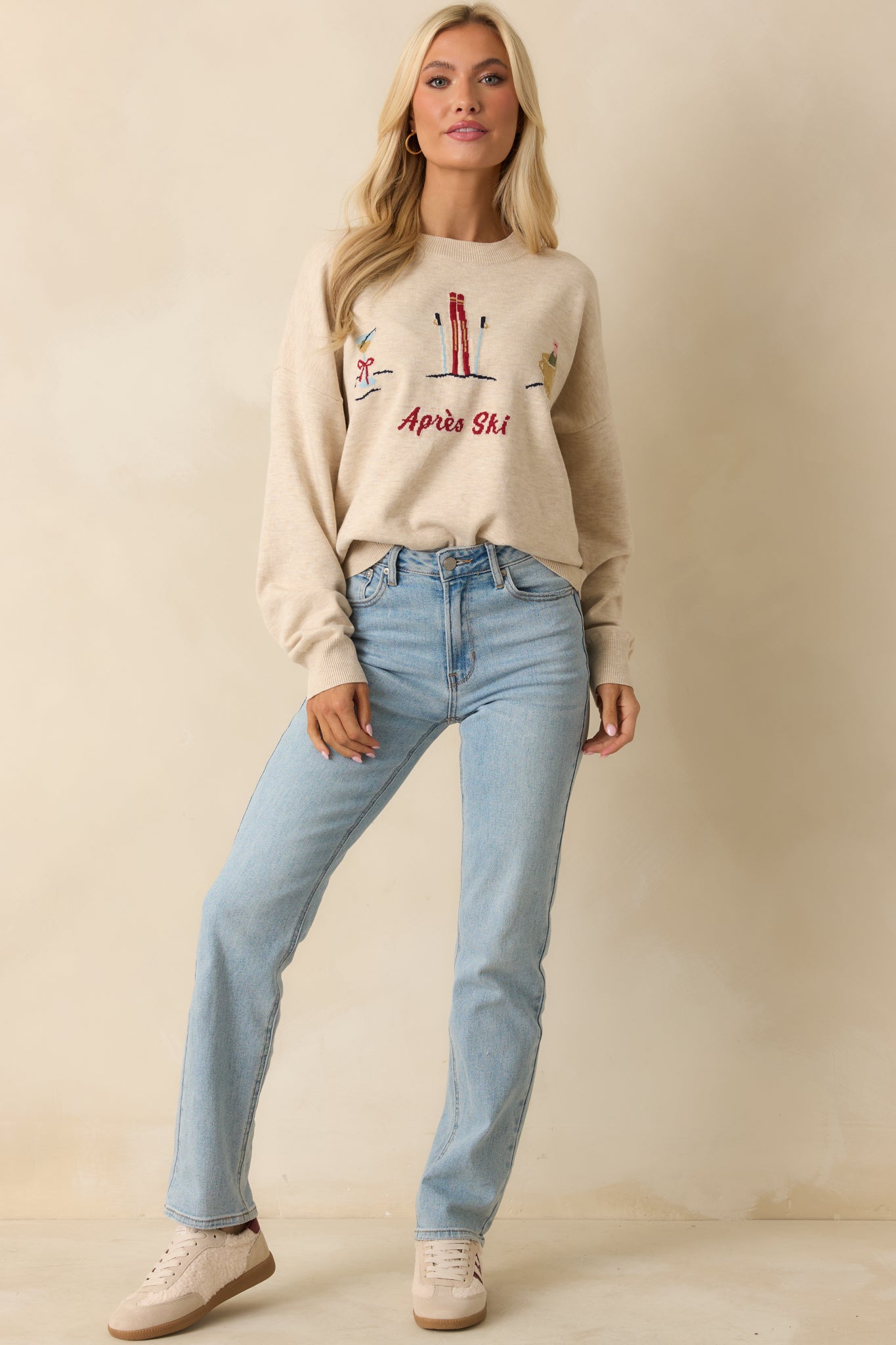 Front-facing full body view emphasizing the cozy knit, ribbed hem, and festive “Après Ski” embroidery.