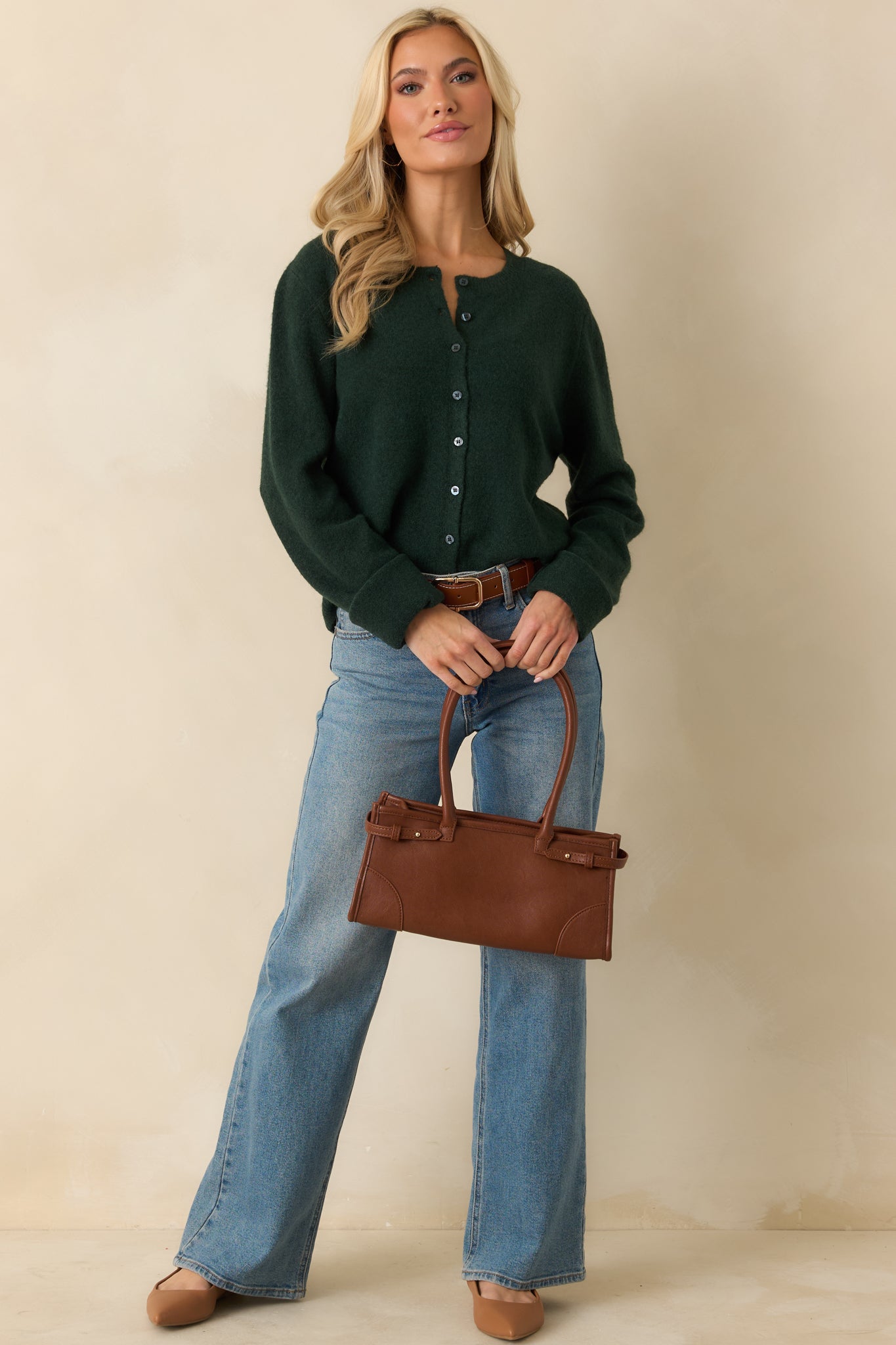 Front view of green button-front cardigan showing crew neckline, ribbed trim, and relaxed fit.