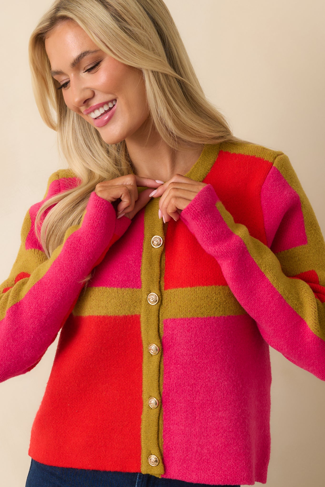 The front midsection displays the gold-tone buttons against the pink and red color blocks.