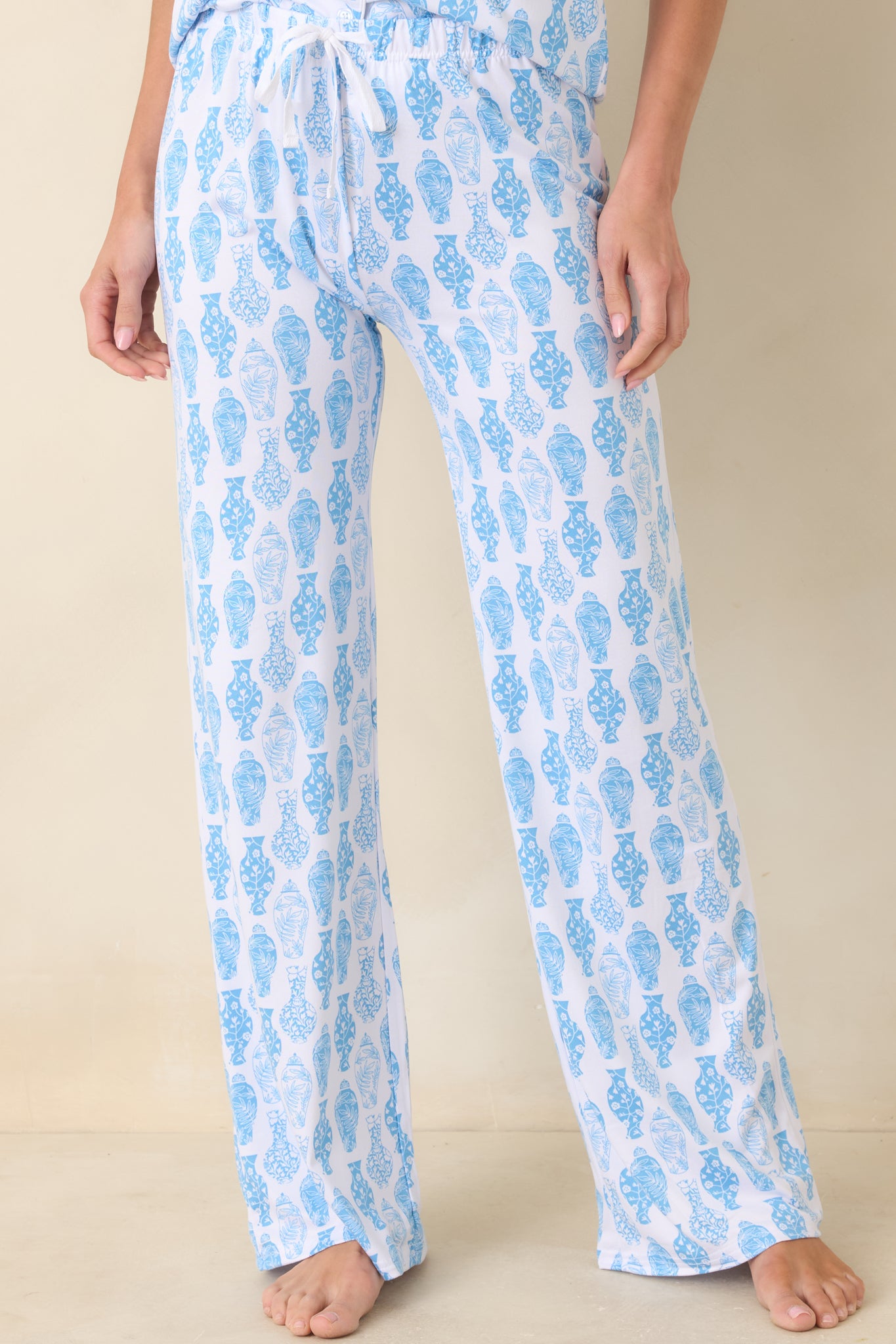 Cropped view of front pant legs highlighting straight-leg cut and Chinoiserie vase-inspired pattern.