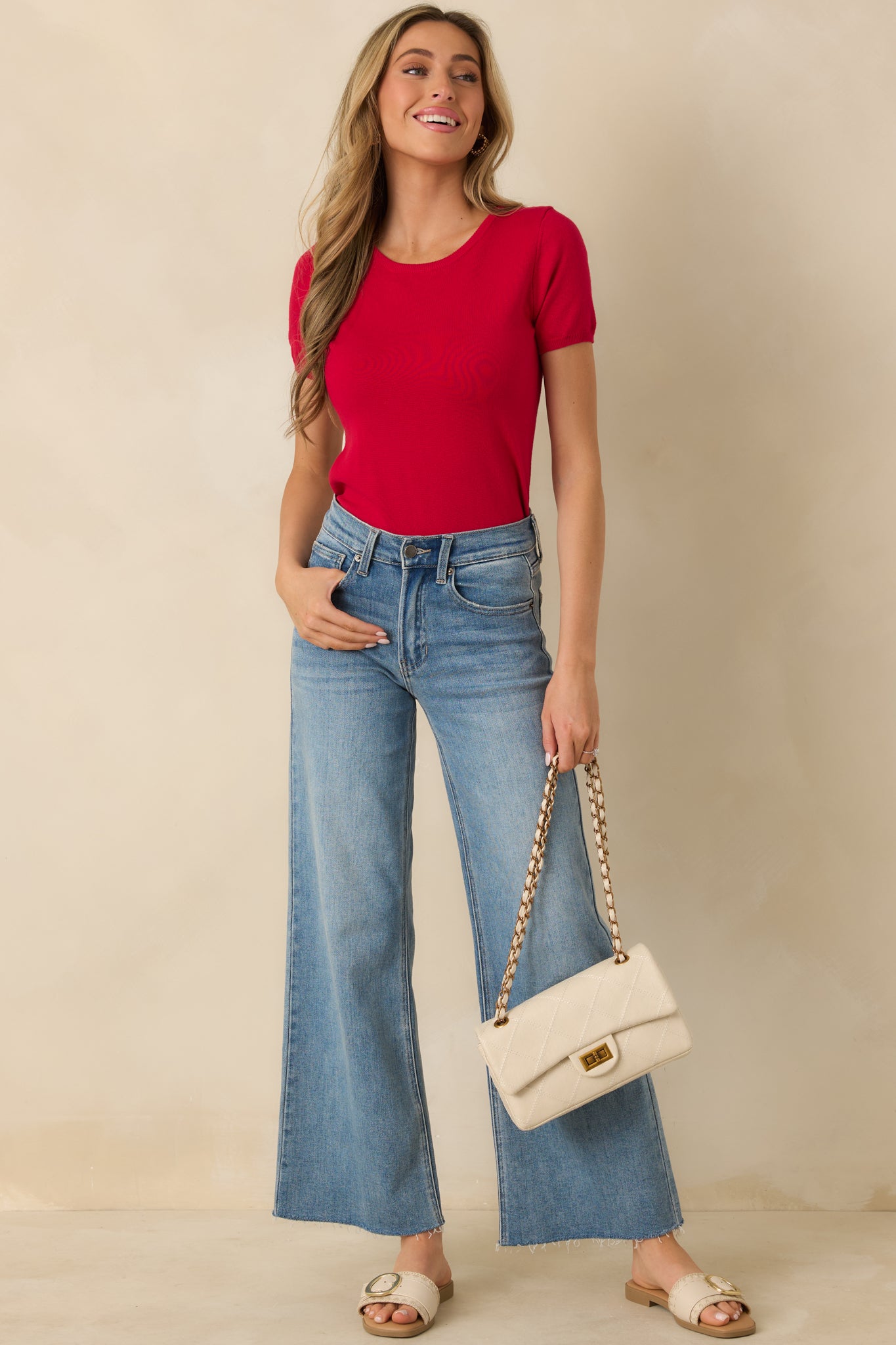 Front-facing red sweater top showing relaxed fit, ribbed hem, and short sleeves.