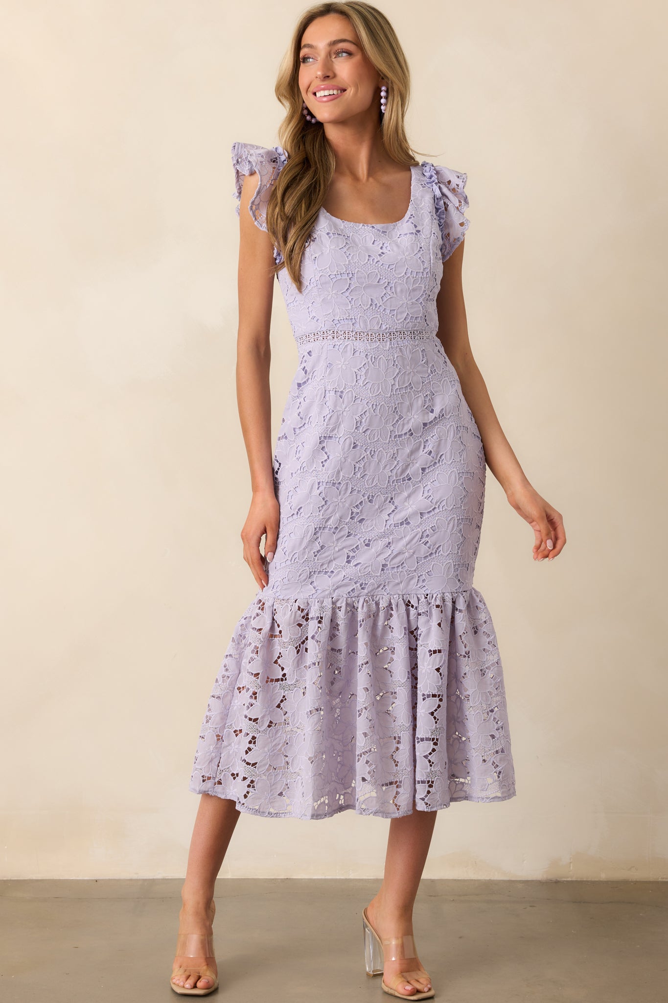 A front angle shot emphasizing the tiered skirt’s gentle drape and the contrast between the embroidered overlay and the lining.