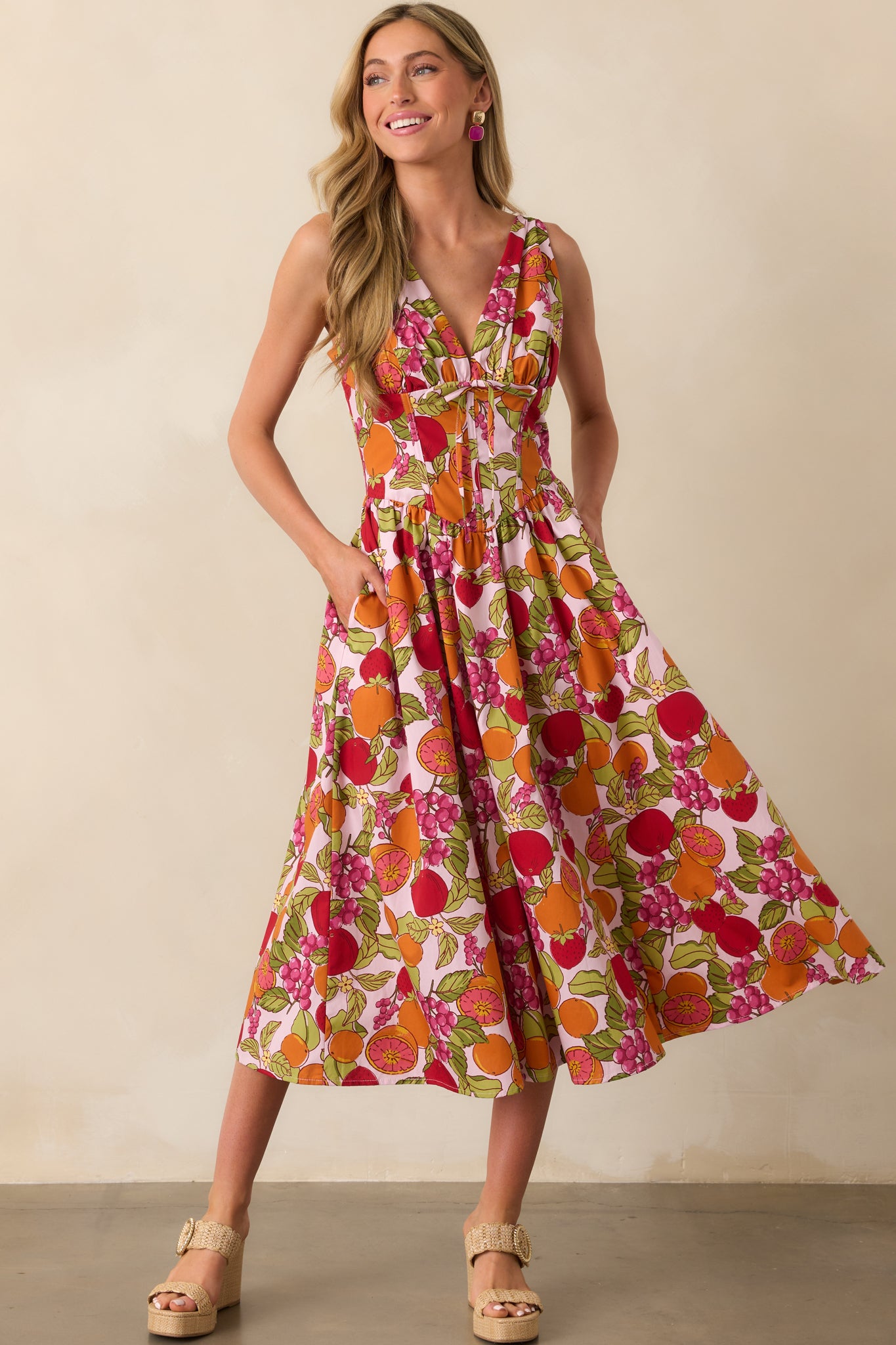 Front-facing shot highlighting the vibrant fruit print, adjustable shoulder straps, and flowing maxi-length skirt.