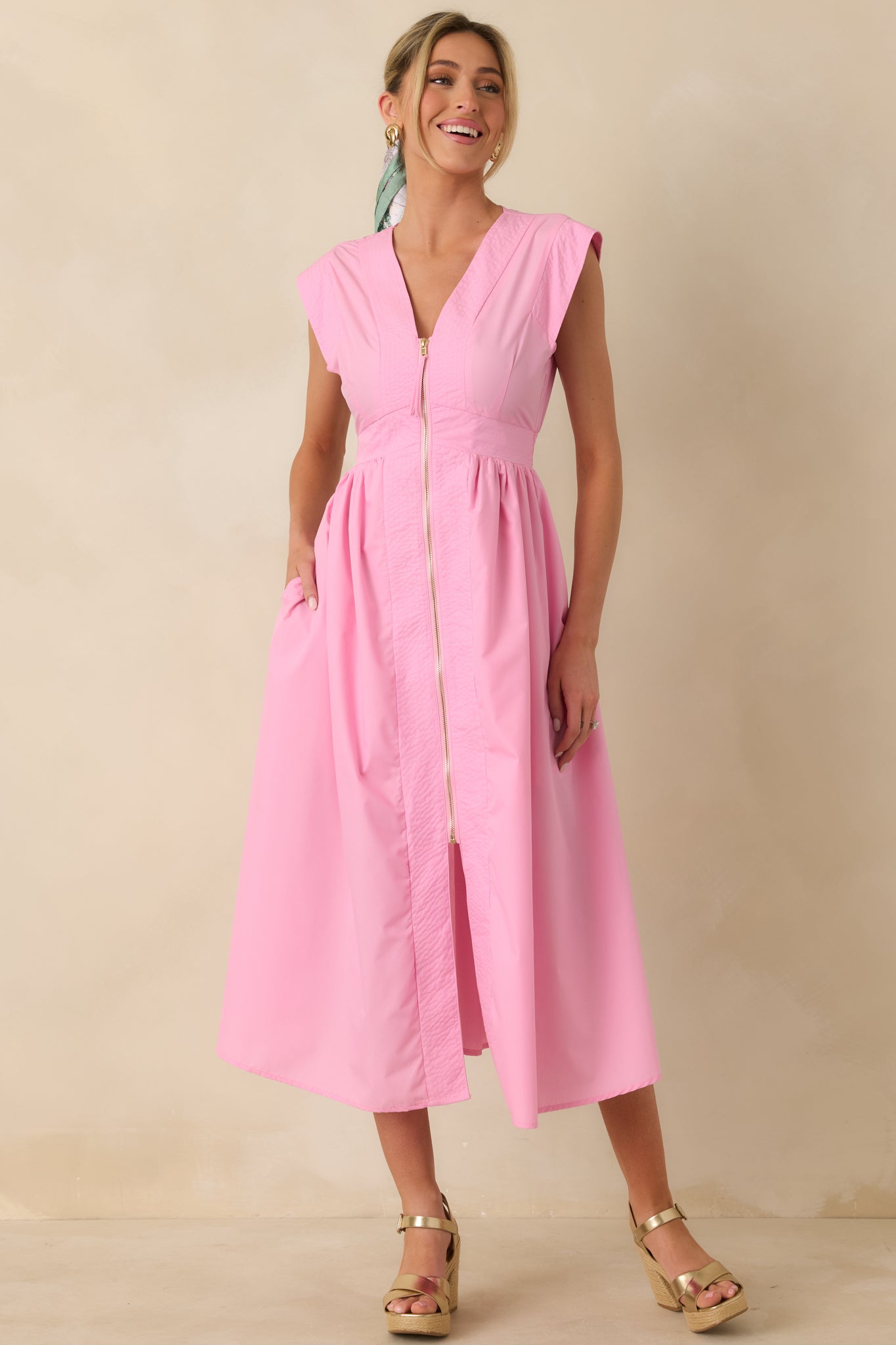 Front-facing full length shot highlighting the clean sleeveless cut, centered zipper detail, and fluid midi skirt silhouette.