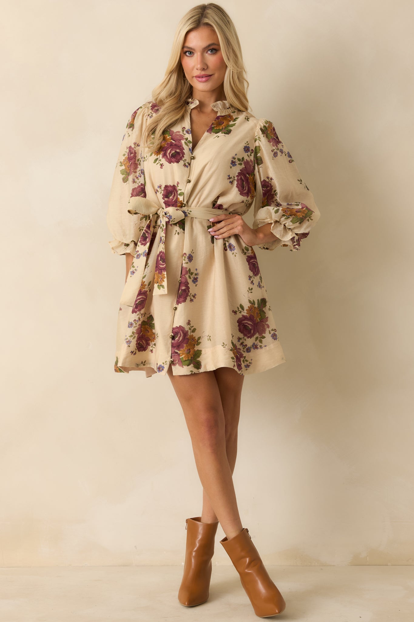 Front view of beige mini dress highlighting the self-tie waist belt and side pockets.