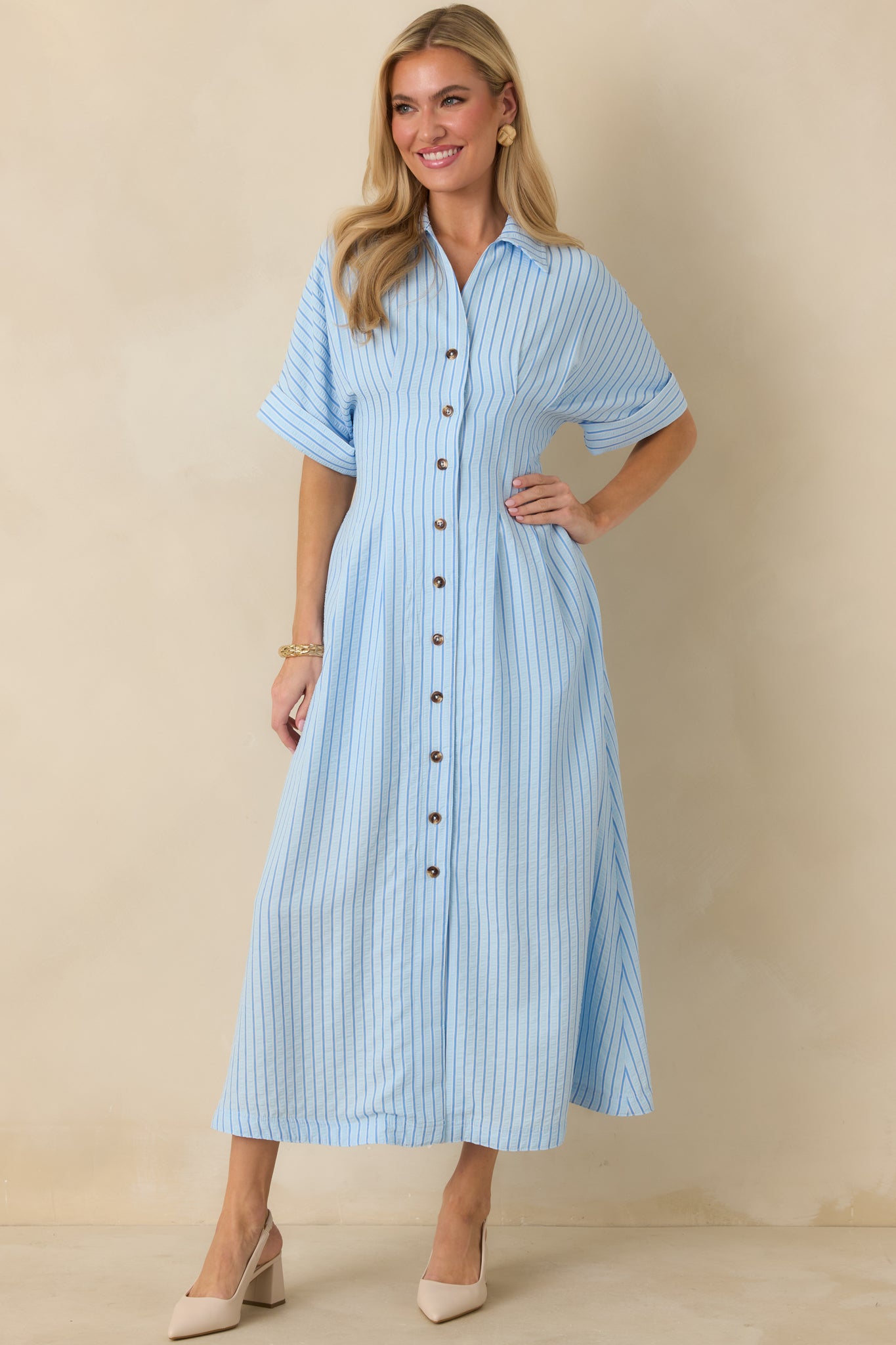 Front-facing view emphasizing the easy, relaxed silhouette and soft drape of the blue striped maxi dress.