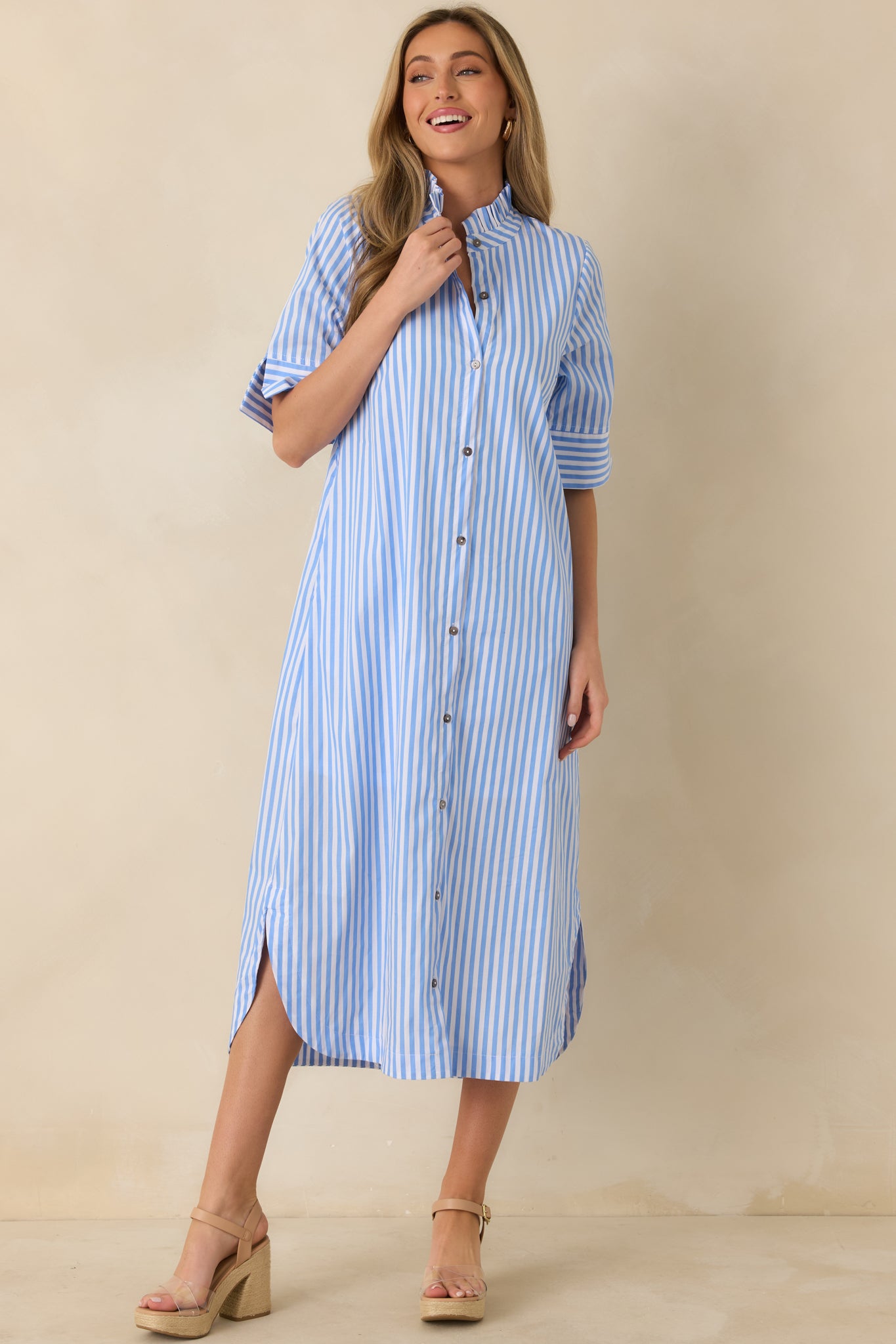 Front view of blue striped shirt dress showing short sleeves and lightweight woven fabric drape.