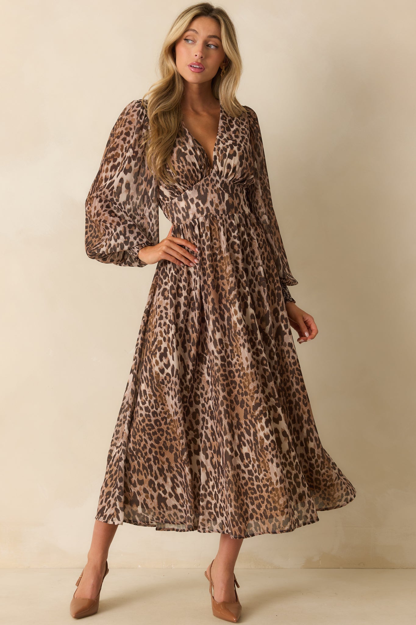 A front view of the brown leopard print chiffon maxi dress with a deep v-neckline, long balloon sleeves, and fitted waistband.