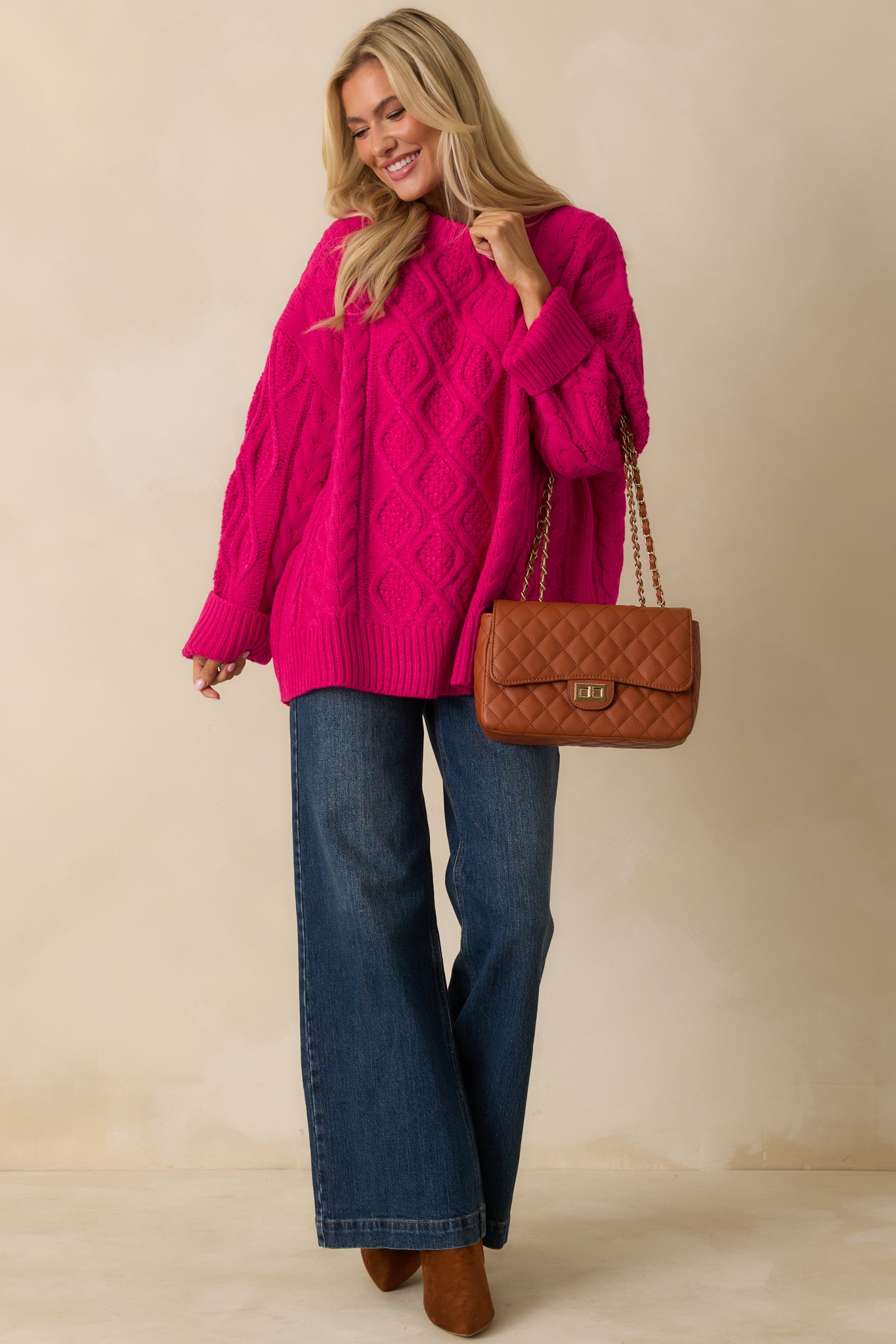 Front view of the cable knit sweater showcasing the textured pattern and relaxed styling.