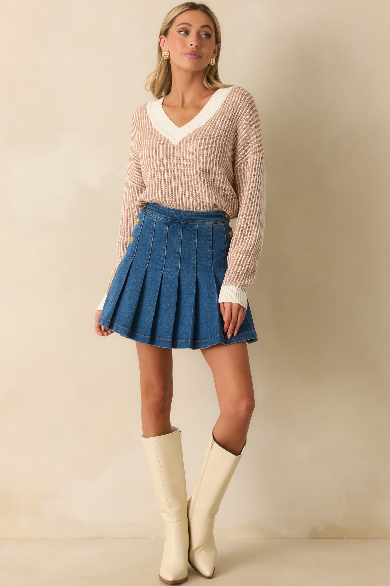 Front view of a camel brown and ivory striped sweater with ribbed hemline and comfortable drape.