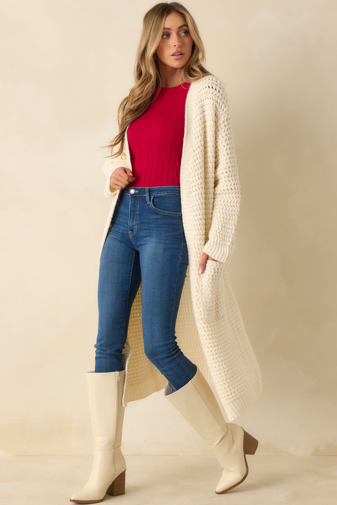 Front view of cream knit duster cardigan with open front, long sleeves, and relaxed longline silhouette.