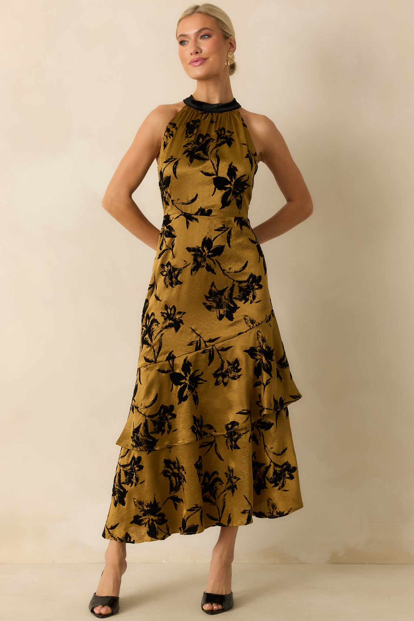 Front view showing the dark gold floral satin midi dress with halter neckline and tiered skirt.