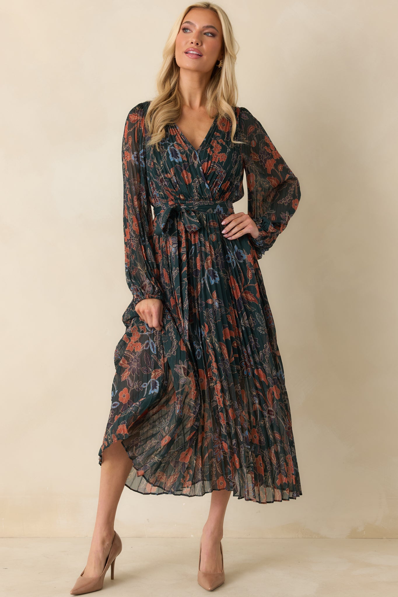Front view of dark green floral maxi dress with surplice wrap bodice and long sheer sleeves.
