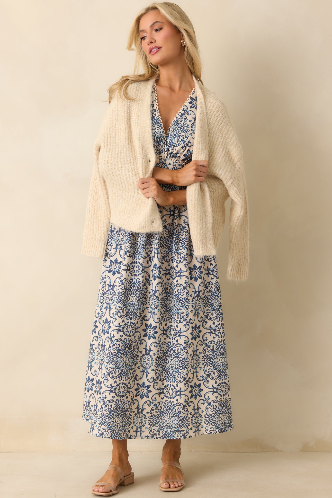 Front view displaying the dress with the scalloped trim along the bodice and the flowing skirt.