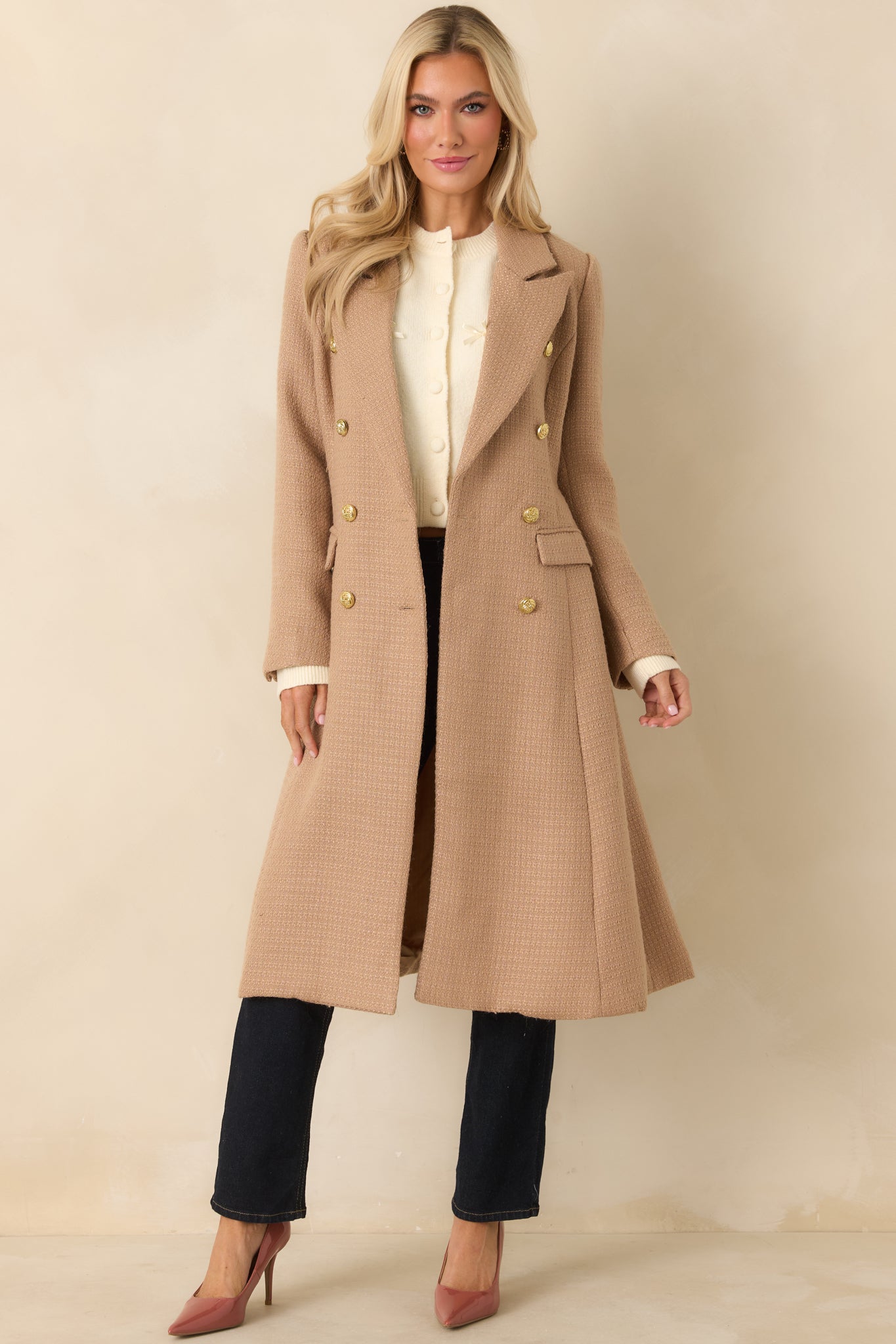 Front view emphasizing the textured woven fabric and structured fit of the double-breasted camel coat.