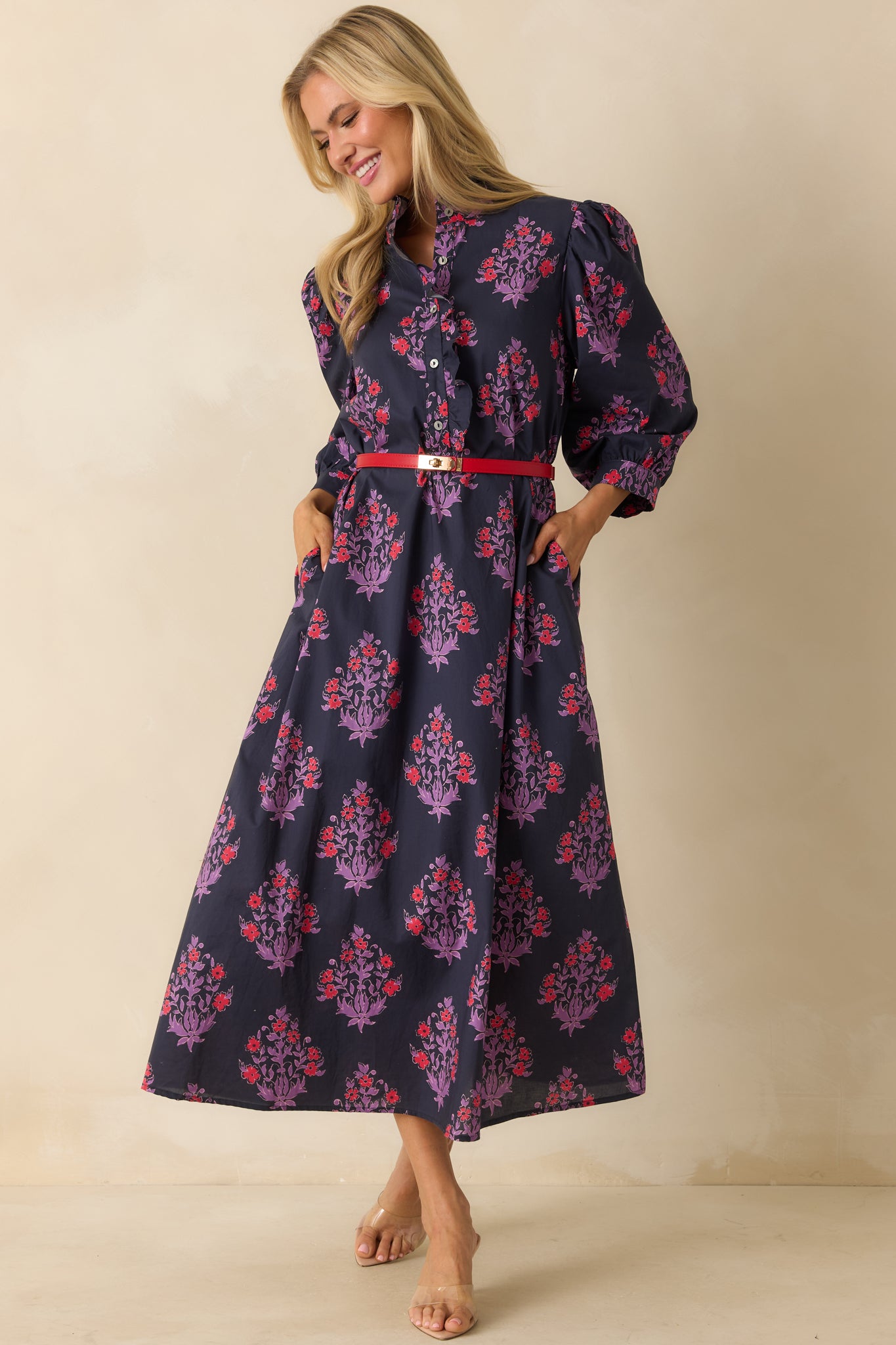 Front-facing floral dress showing the puff sleeves with button cuffs and relaxed maxi-length shape.