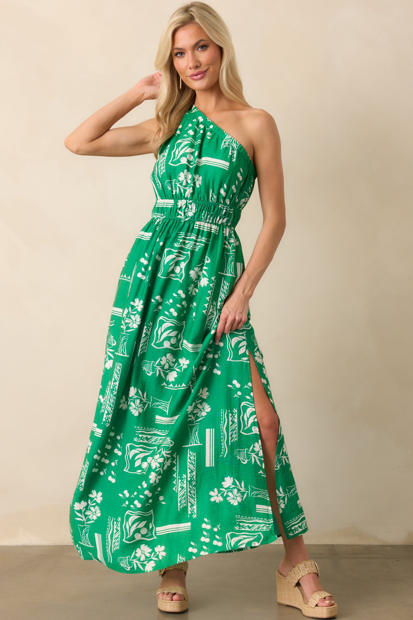 Green maxi dress with white geometric floral print, featuring an elastic waist and side leg slit shown front-facing.