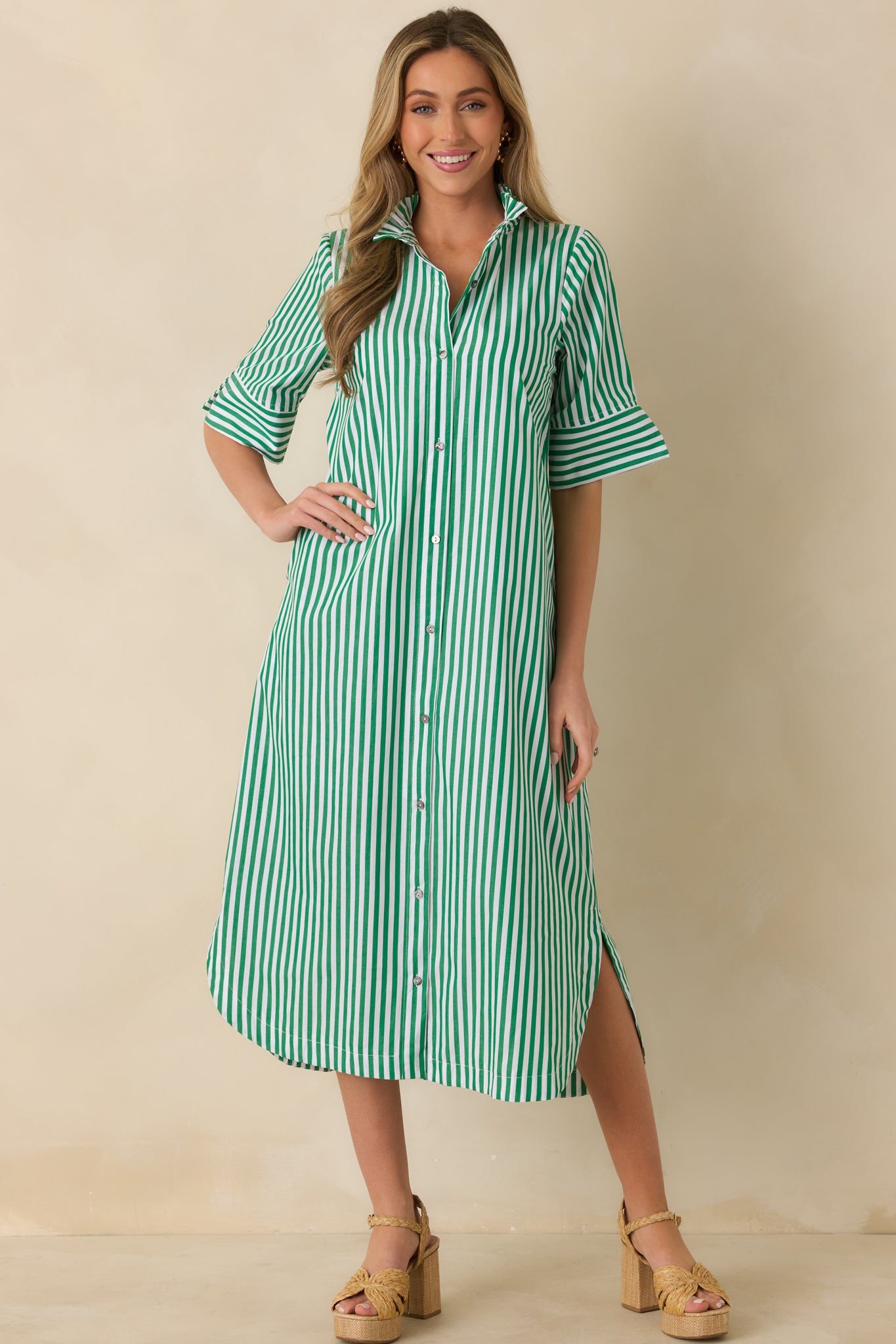 Front-facing view of green striped shirt dress showing short sleeves and lightweight woven fabric.