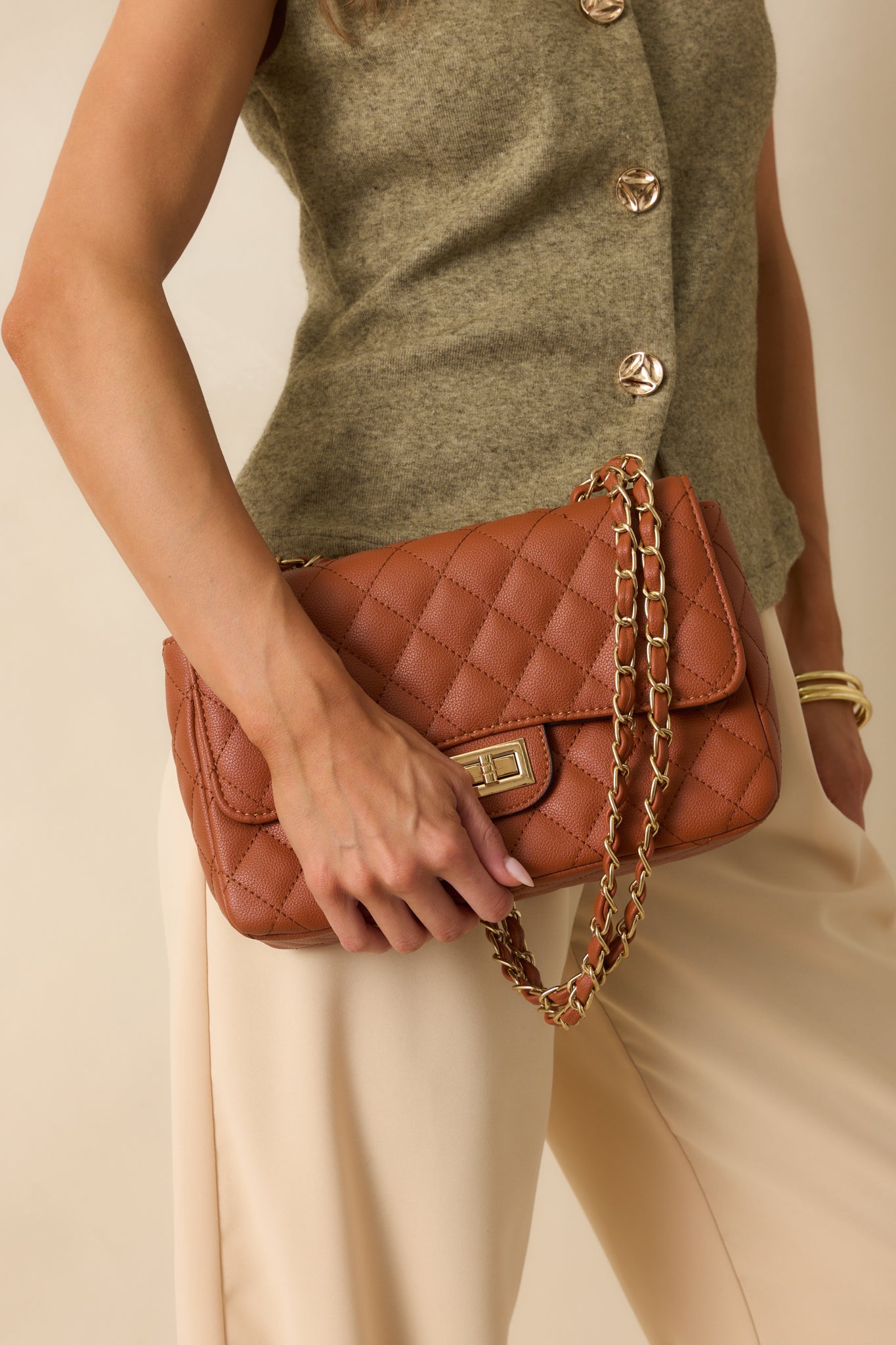 Front view of the handbag highlighting its structured quilted exterior and elegant chain strap.