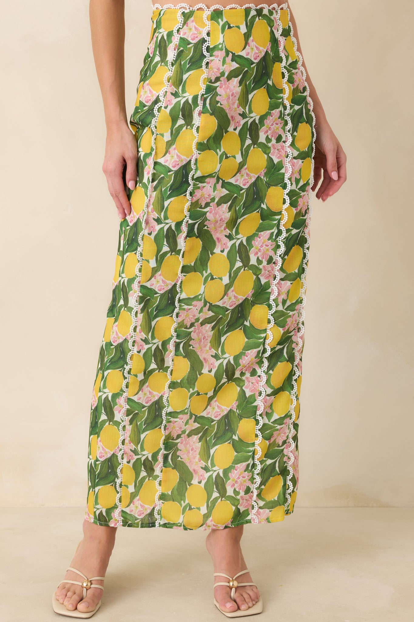 Front view highlighting the fitted waistband and vertical scalloped lace panel accents along the yellow lemon blossom fabric.