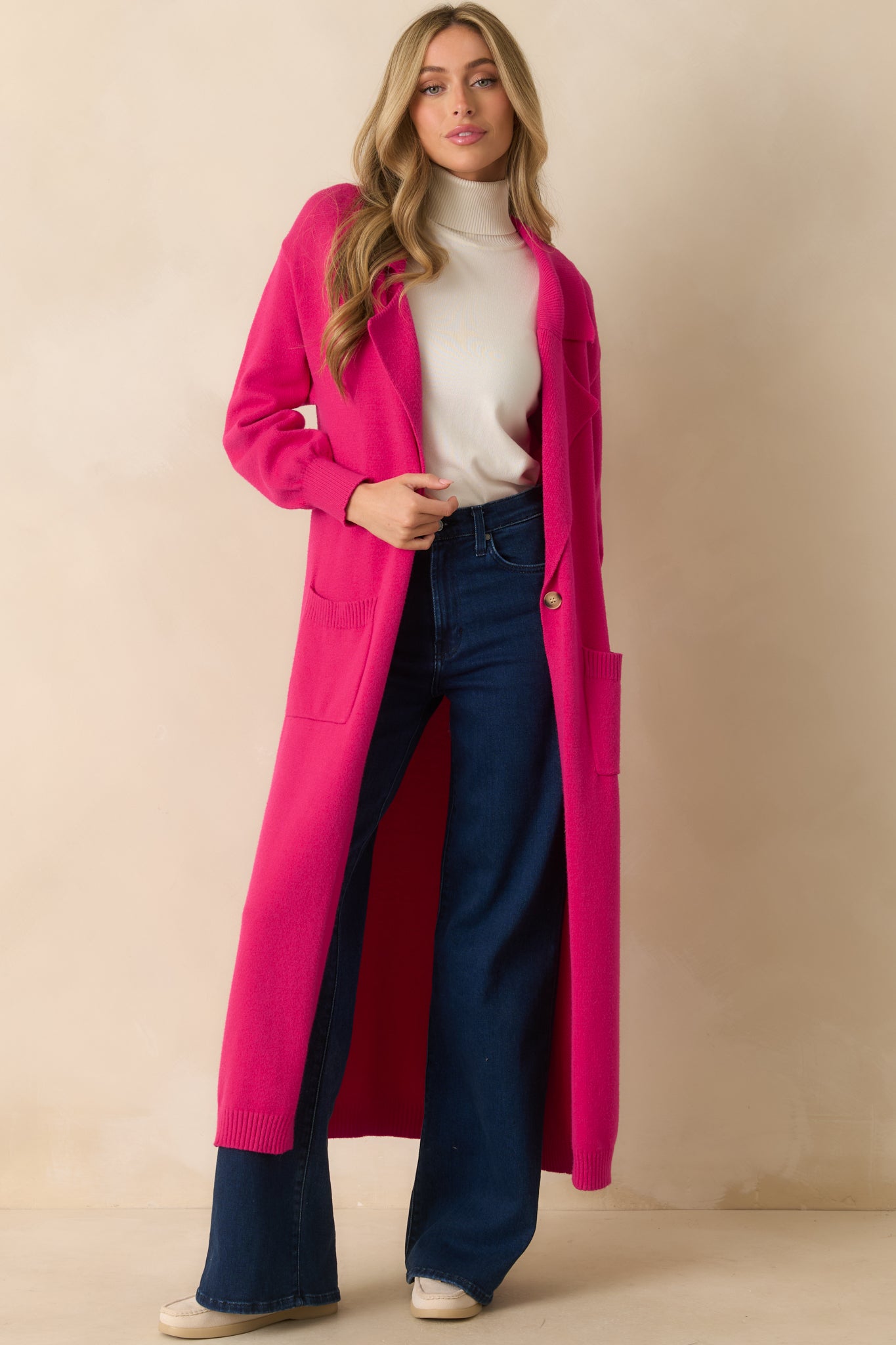 Front view of the hot pink cardigan featuring a lapel collared neckline, single button closure, and long sleeves.