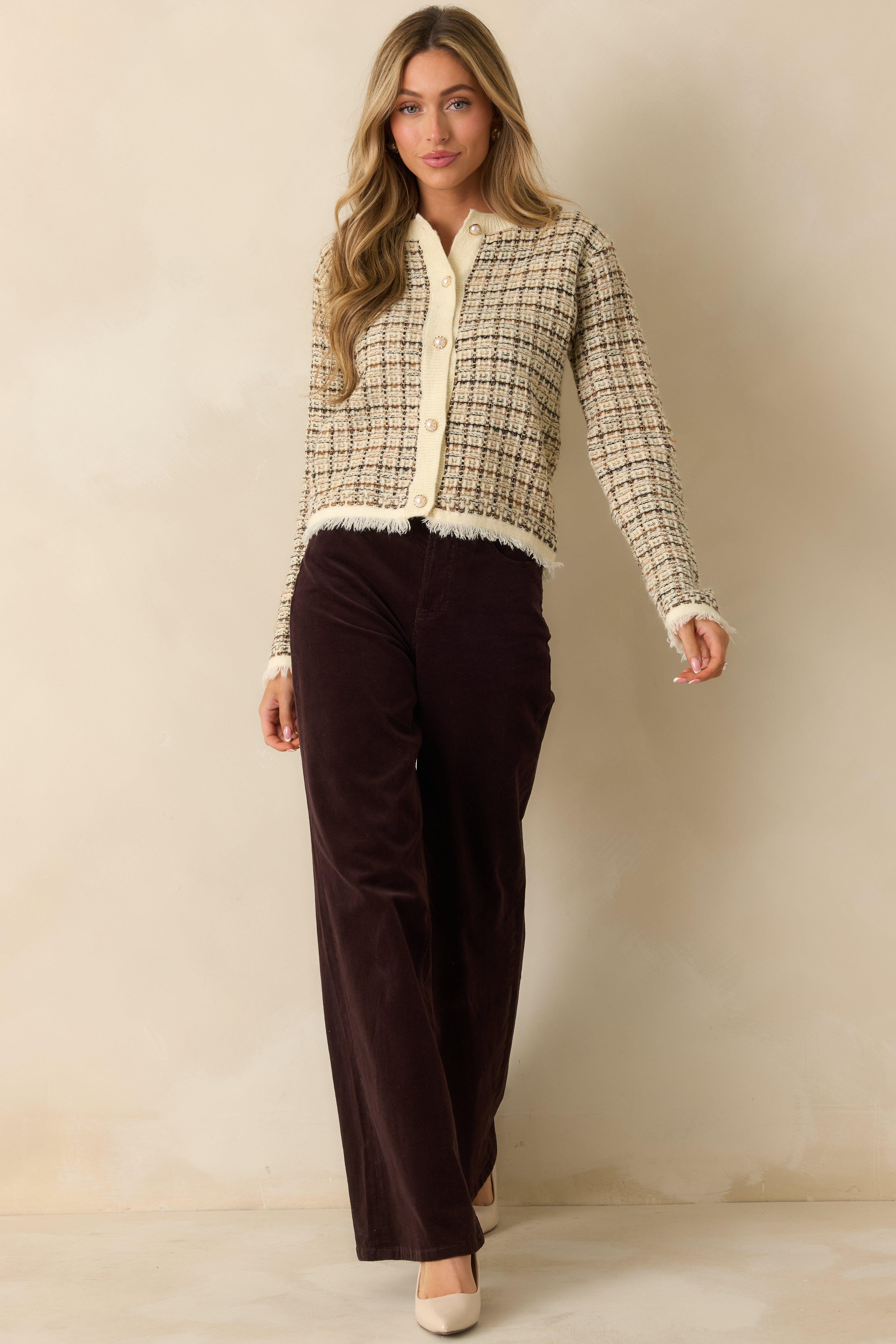 Front-facing ivory cardigan with long sleeves, patch pockets, and subtle fringe hem in woven plaid with golden highlights.
