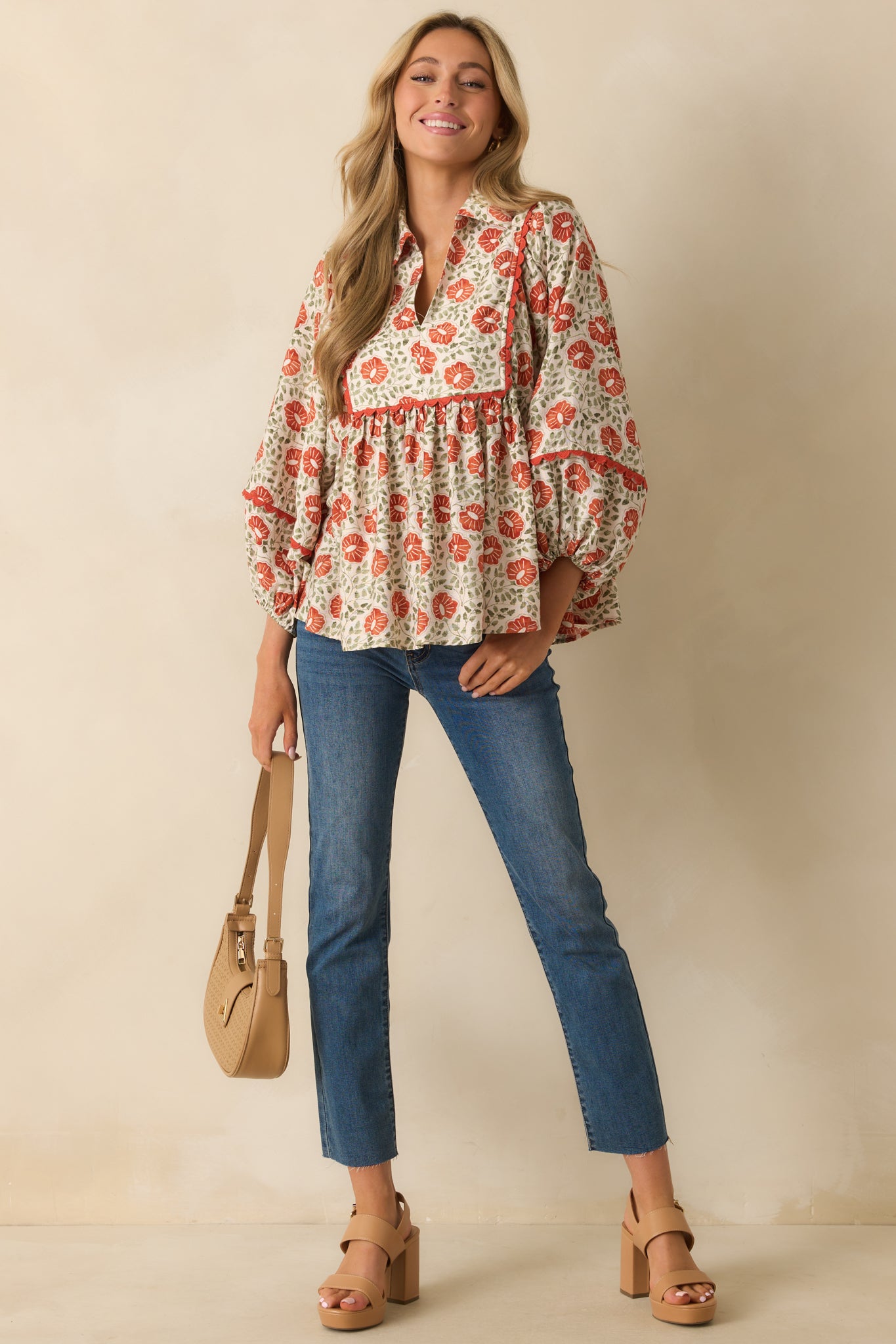 A front-facing image showing the long sleeves and multicolor floral print across the top.