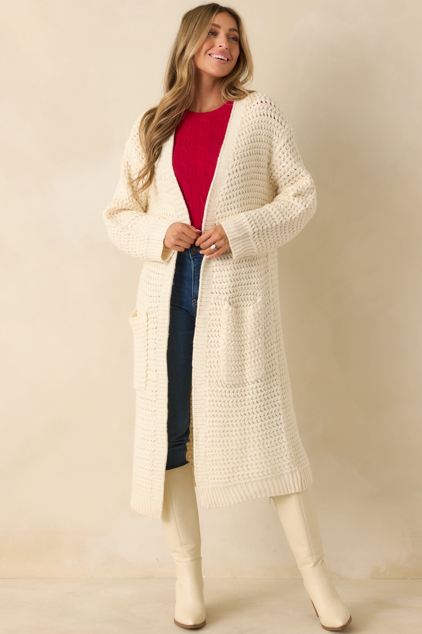 Front view showing longline fit, open front, and casual drape of cream knit duster.