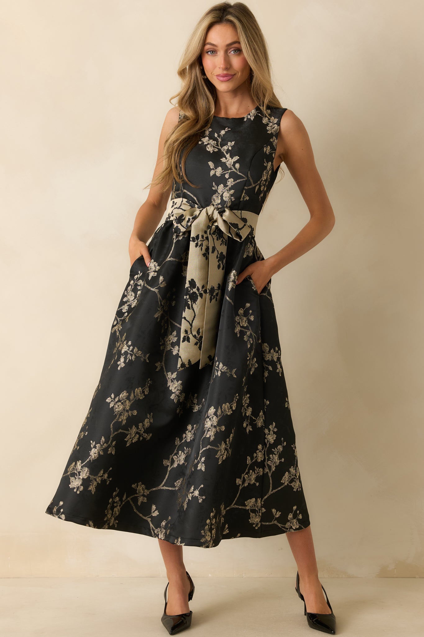 Front view highlighting the metallic tie belt and structured fit of the floral jacquard fabric.
