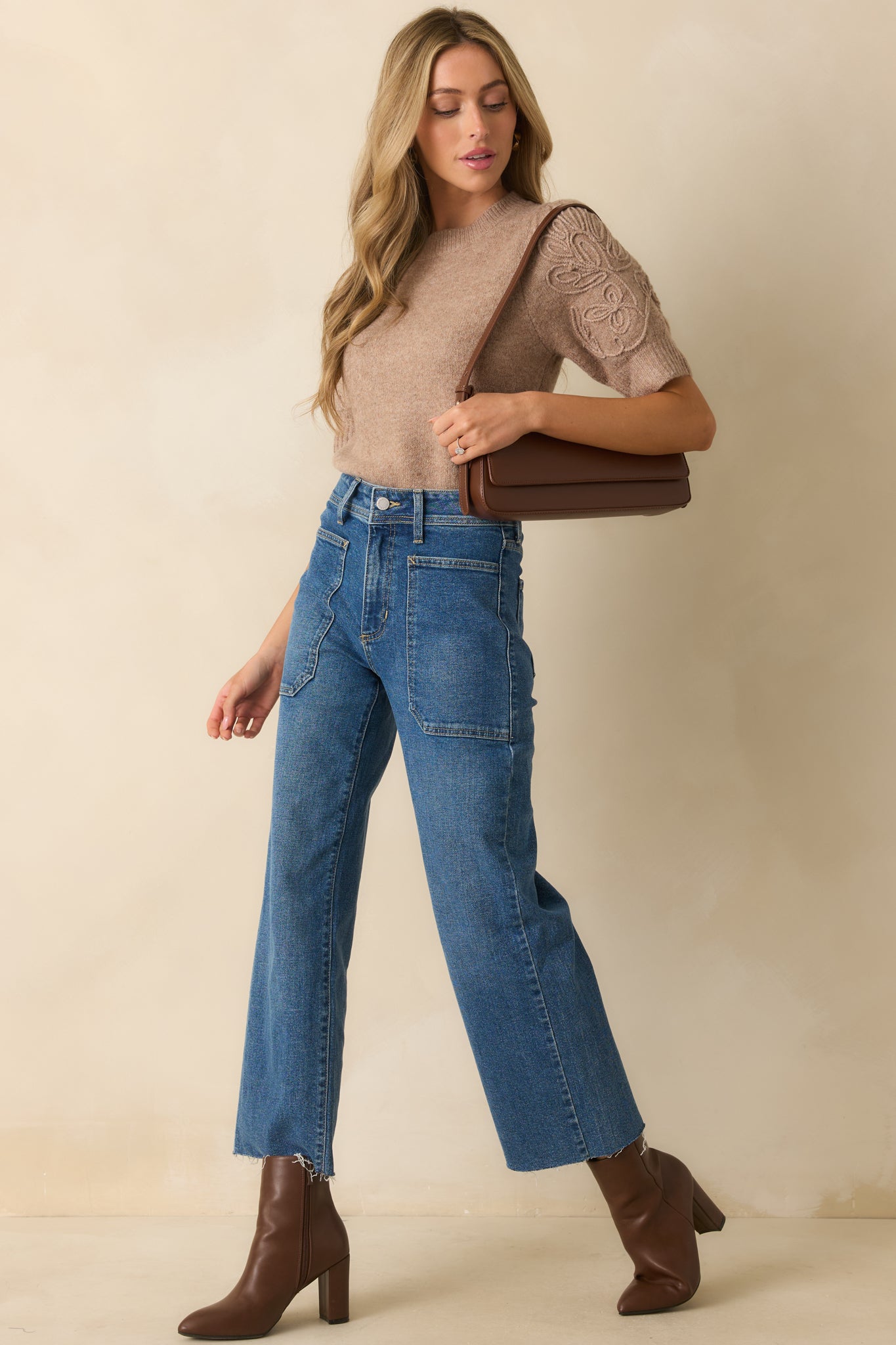 Front view of the mocha knit sweater featuring a crew neckline, short puff sleeves, and ribbed trim throughout.