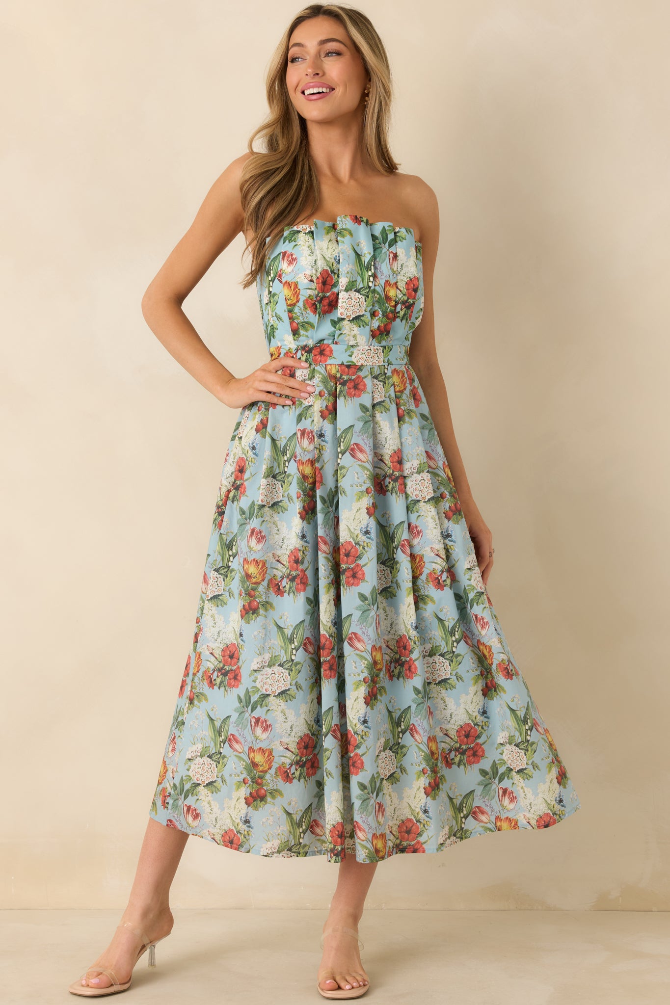 Angled front view of the blue floral dress emphasizing the pleated skirt and flowing silhouette.
