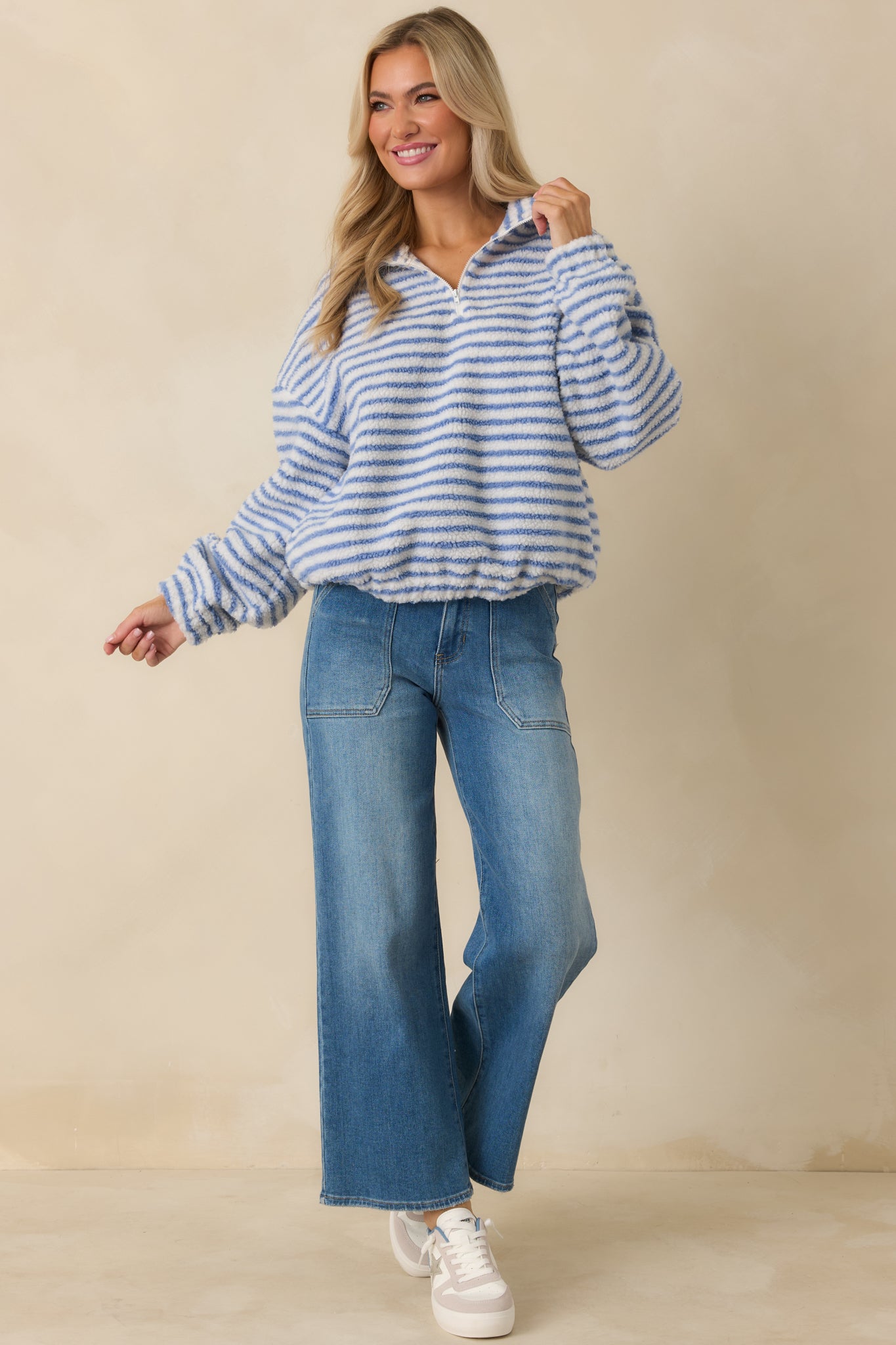 Front view of blue striped pullover featuring soft textured knit, long sleeves, and banded cuffs.