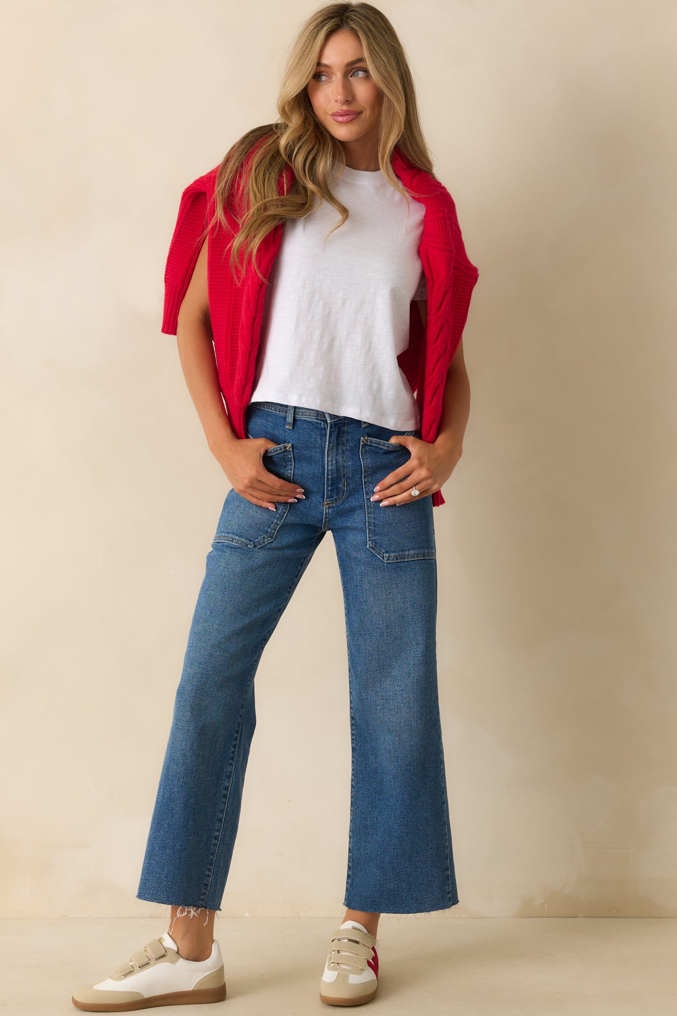 Front view of medium wash utility jeans with high-rise waist, wide-leg silhouette, and raw-cut hem.