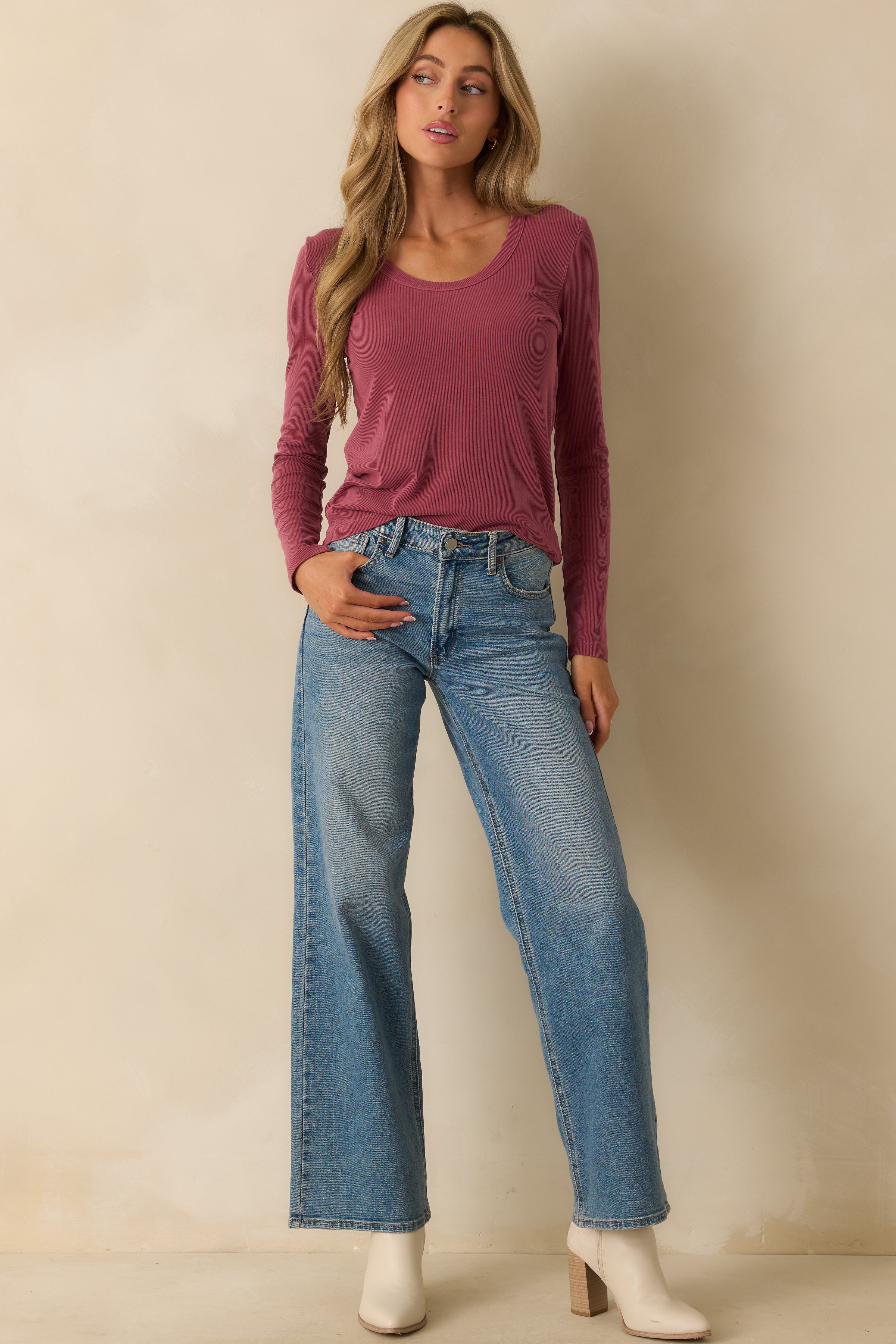 Front view of the plum purple top showing the scoop neckline and long sleeves with a relaxed fit.