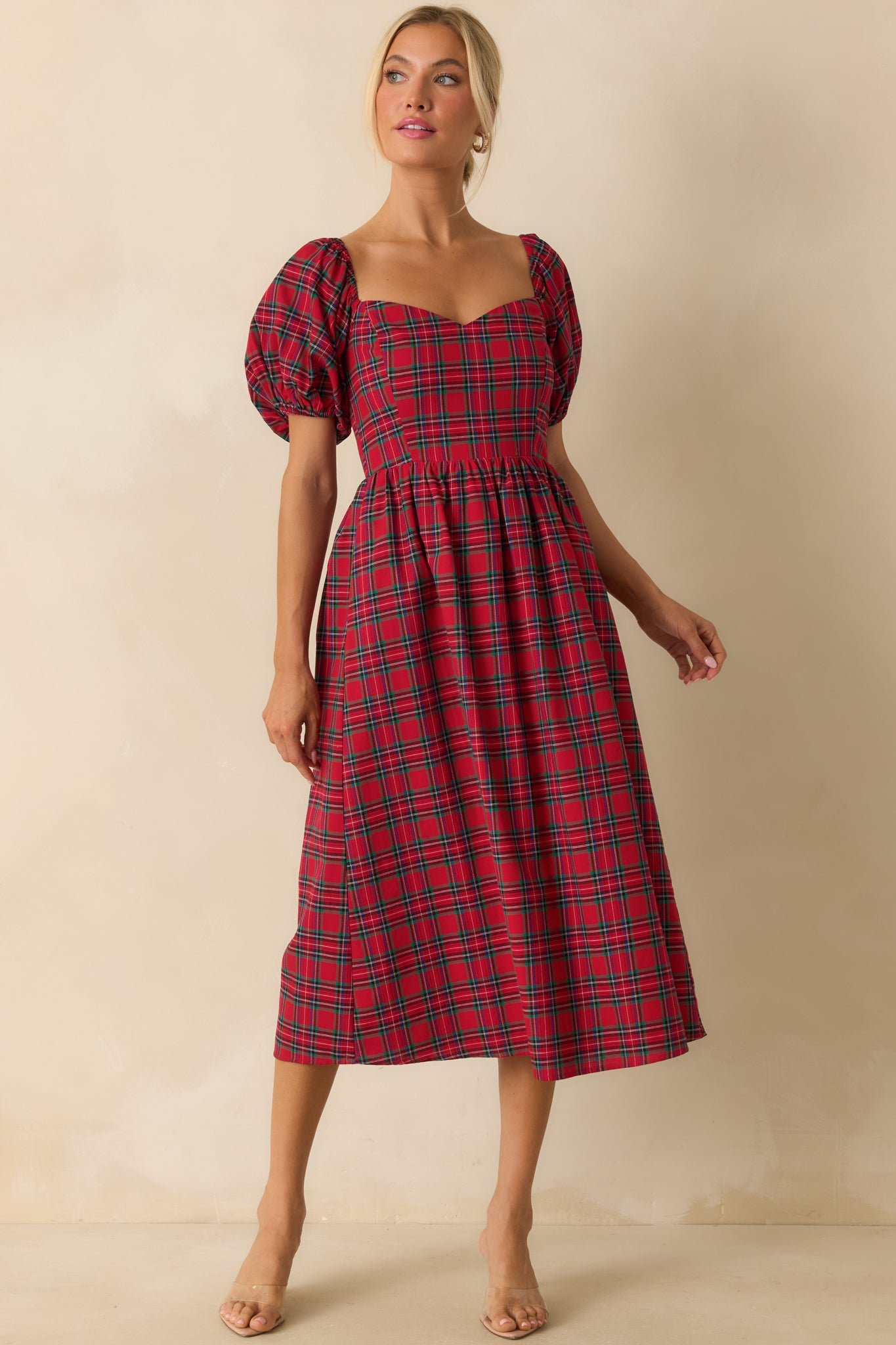 Front view of red dress featuring short puff sleeves, fitted bodice, and plaid pattern.