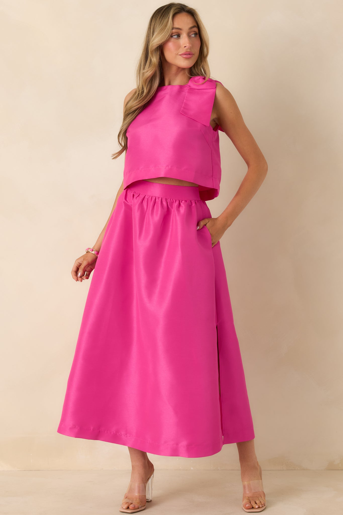 Front-facing view highlighting the relaxed boxy silhouette and straight hem of the fuchsia top.