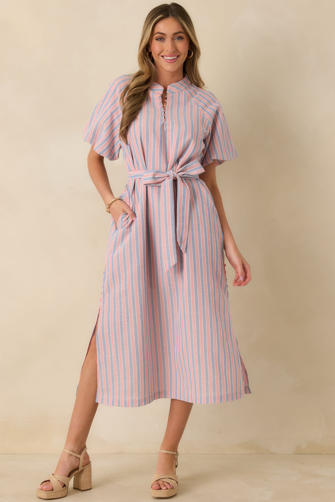 Full-length front view showcasing the round neckline, clean silhouette, and waist-defining self-tie belt.