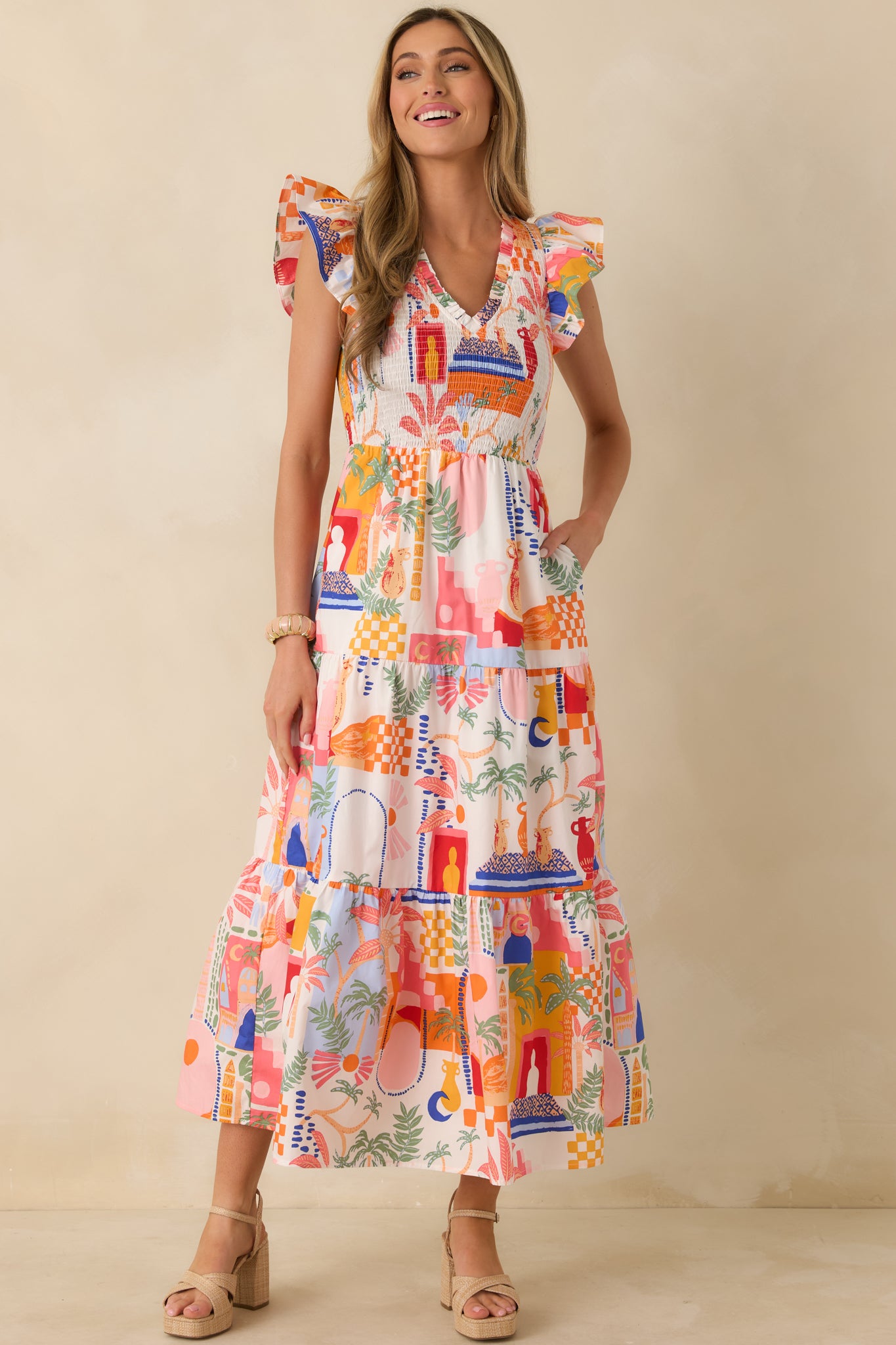 Full-length front view showcasing the V-neckline, smocked bodice, and flowy, tiered maxi skirt.
