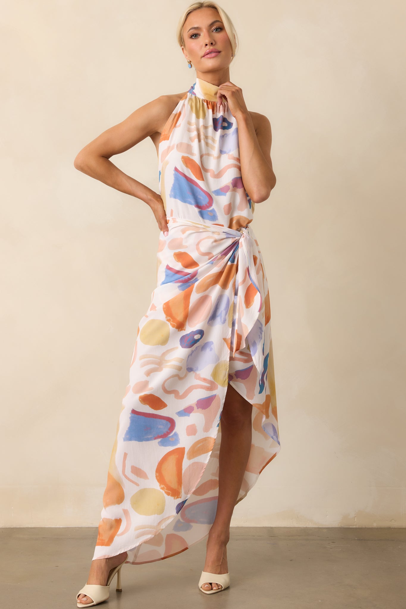 Front view showing the wrap-style front with snap button closure and the placement of the abstract print throughout the skirt.