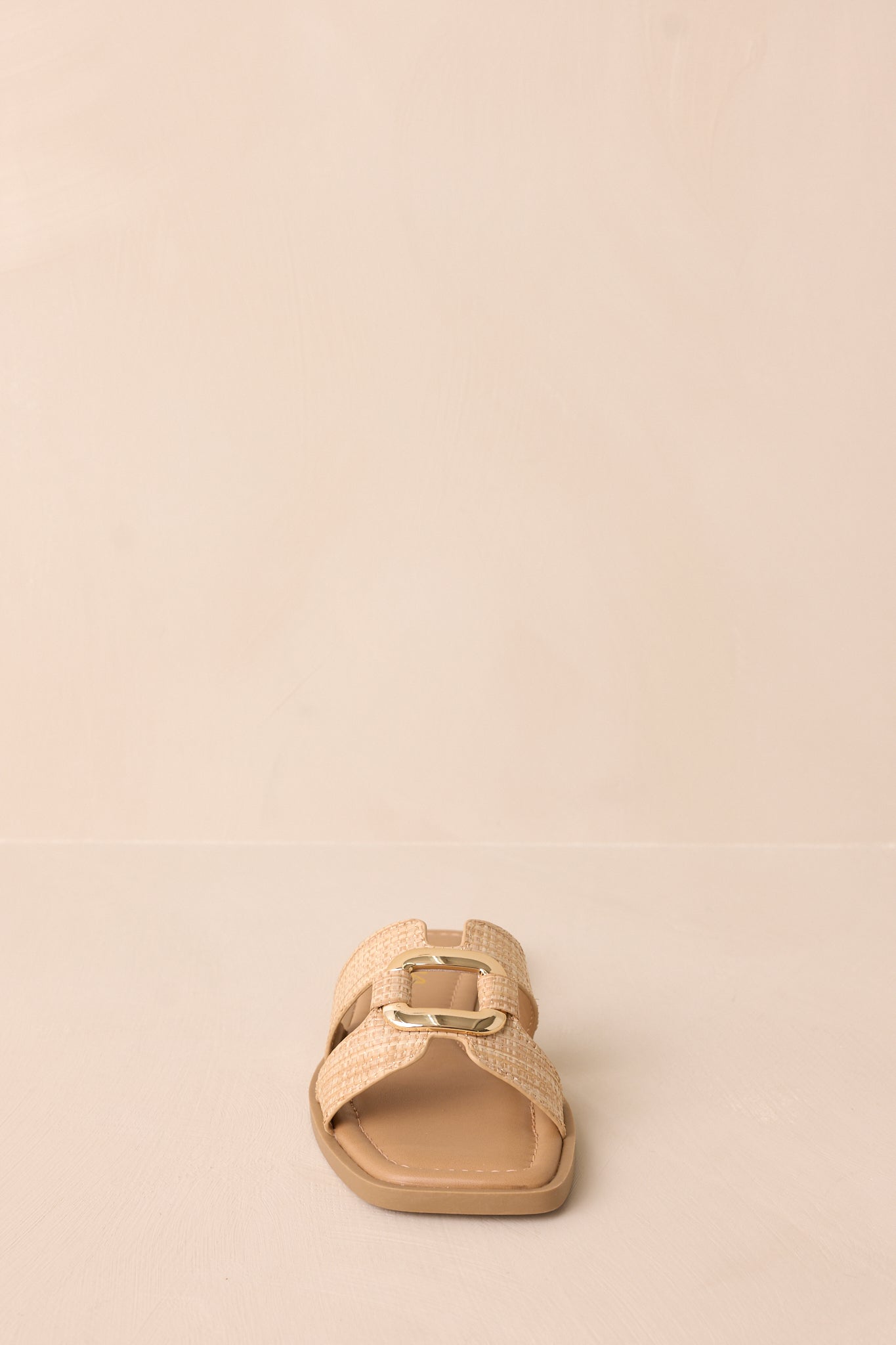 A straight-on front shot emphasizing the square toe design and tan strap detailing.