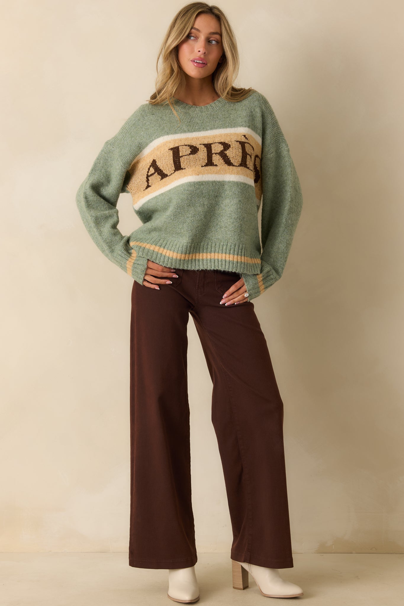 Front view of the sweater highlighting the “APRÈS” lettering across the chest and relaxed fit.
