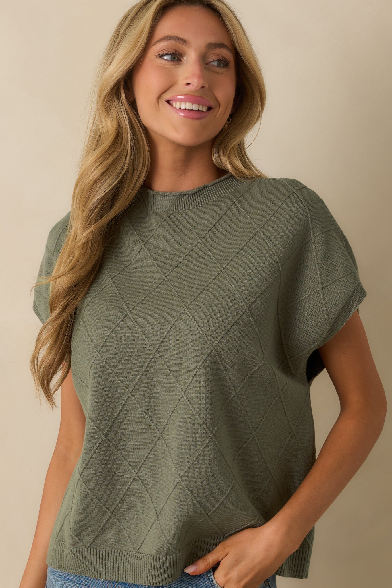 Front view focused on sweater body, showcasing argyle detailing and fabric texture.