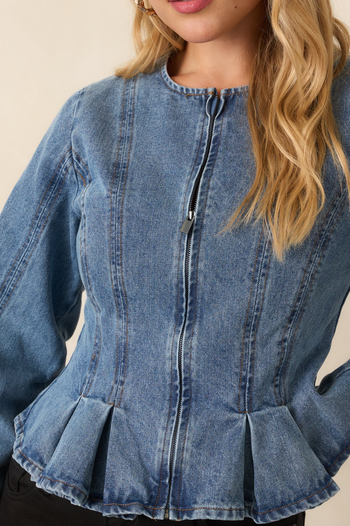 Close-up of the front zipper, sculpting seams, and cotton texture.