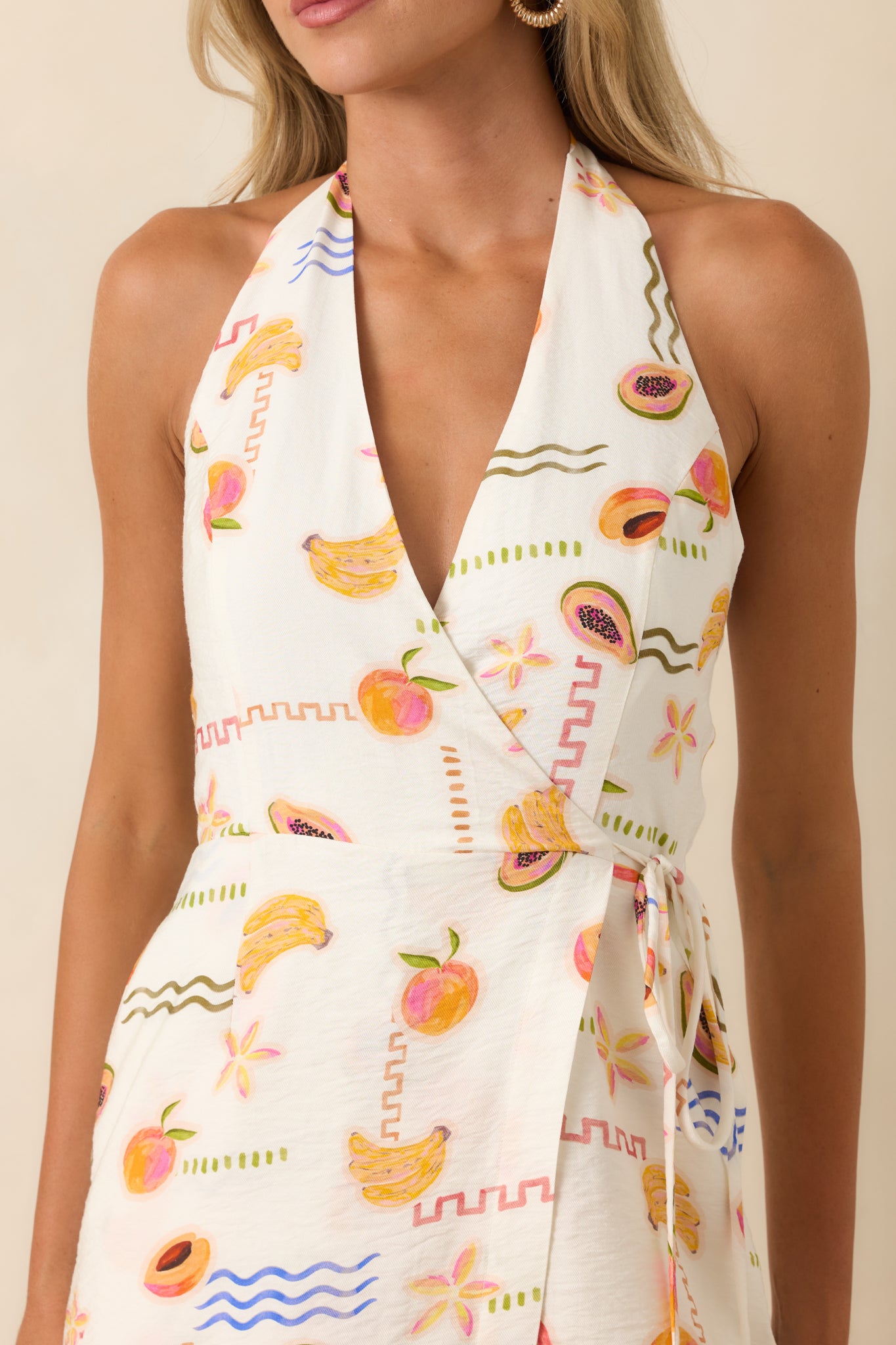 Close-up of the vibrant fruit print featuring peaches, bananas, passionfruit, and coastal graphic details.